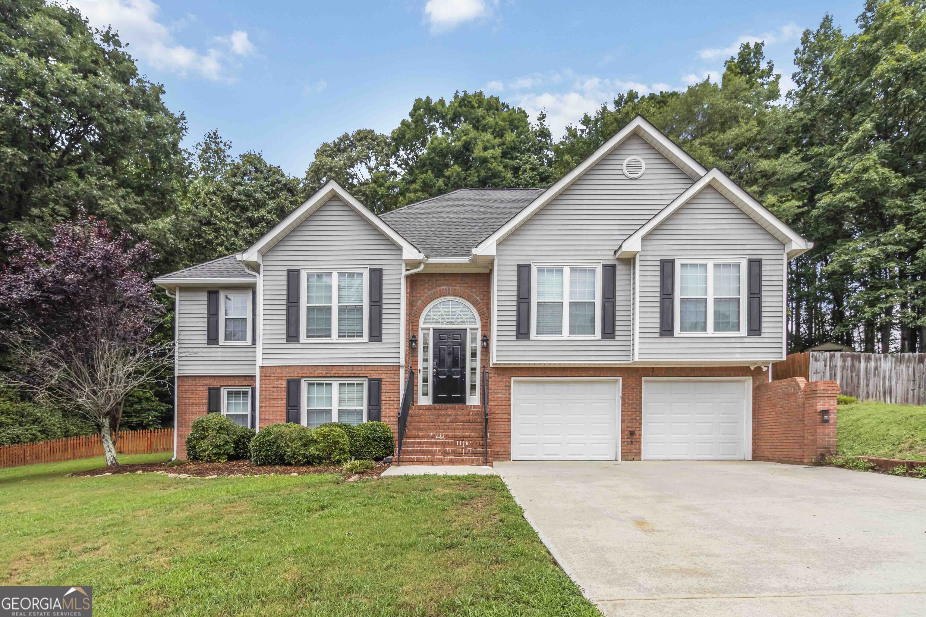 Welcome to this 5-bedroom, 3-bath home designed for comfort, convenience, and style. The open floor plan creates a bright and airy feel, featuring a spacious family room with a cozy fireplace and a kitchen that's perfect for entertaining complete with white cabinets, stainless steel appliances, and a generous dining area. Retreat to the primary suite with a stunning trayed ceiling and an en-suite bath that includes a stepless shower, ideal for ease and accessibility. Downstairs, you'll find a second living room with a fireplace, plus a dedicated office space perfect for remote work or hobbies. Enjoy the outdoors year-round from the screened porch with ramp access or host gatherings on the expansive deck overlooking the fenced backyard. Additional storage in the backyard shed. With thoughtful upgrades throughout, this home offers the perfect blend of functionality and charm. Don't miss your chance to own this home and make it yours.