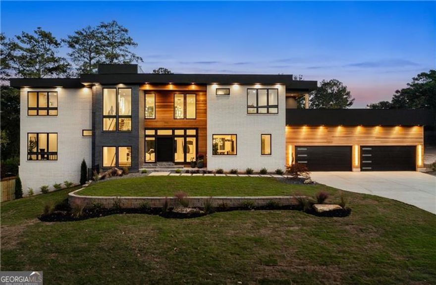 Welcome to this extraordinary modern estate, an architectural gem with a bold flat roofline, rooftop balconies, and an interior that radiates sophistication and style at every turn. Spanning multiple levels, this one-of-a-kind residence features a striking open floor plan, anchored by a two-story great room with floor-to-ceiling windows and a linear gas fireplace. The heart of the home is the chef's kitchen that is nothing short of world-class: fully equipped with Sub-Zero and Wolf stainless steel appliances including double ovens, dishwasher, a dramatic 6-burner gas range, custom-crafted wood cabinetry with LED lighting, a full coffee station, and wine refrigeration. A modern floating staircase with glass railings ascends to the upper level, where you'll find four expansive bedrooms, each with beautiful custom tile design en-suite baths and custom walk-in closets. The primary suite on the main floor offers a gorgeous bathroom with dual sinks, custom tile, soaking tub and walk-in custom closets with LED lighting that is the epitome of luxury in closet design, blending privacy with indulgence in a space designed to soothe and impress. An additional main-level bedroom or executive office adds versatility and convenience. The main level showcases 48x48 custom designer tile flooring, while wide-plank hardwoods bring warmth and elegance to the primary bedroom and upper level. A fully equipped second kitchen-complete with a gas range, refrigerator, sink, and dishwasher-offers added flexibility for entertaining or extended living. The walk-in pantry provides generous storage, and the mudroom, thoughtfully positioned just off the 4-car garage, adds seamless functionality. For ultimate convenience, the home includes two laundry rooms, one on each level. The partially finished basement expands the living space with an additional bedroom, full bathroom, and home gym. Five separate HVAC units ensure optimal comfort and energy-efficient climate control throughout this exceptional residence. Outside, the experience continues with a resort-style pool and spa, an expansive covered outdoor living area with a gas top of the line grill area equipped with stove, and beverage fridge and integrated lighting designed to complement the home's clean architectural lines. Ideally situated in the heart of prestigious Sandy Springs, this exceptional residence offers effortless access to City Springs, top-tier schools, and premier dining-seamlessly blending luxury living with an unrivaled location.