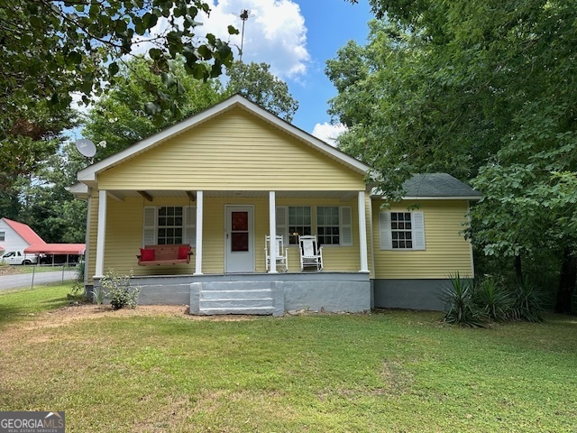 THIS HOME IS A BEAUTY! Ranch home on corner lot in Chatsworth, GA! Covered rocking chair front porch, overlooking a beautiful front yard with chain link fence. Recently painted exterior. 3 bedrooms, 1.5 baths, almost new HVAC system including duct work. Remodeled! New paint - inside and out! New flooring and new bathroom fixtures. Deck on back for fun entertaining! Corner lot has several shade trees and flowers. No Homeowners Association or fees! Concrete driveway with at least 2 parking spots. The yard is fenced in front and side of house. Bring your doggies or family pets. A country feel yet not far from city of Chatsworth! Close to Carters Lake, only 5 or 6 miles to the powerhouse and spillway. Picnic and fish and bring your boat to Carters Lake! Really nice scenery! Approximately 20 miles to Ellijay!! Shopping available in Chatsworth or make the drive to beautiful Ellijay for a variety of restaurants and shops!