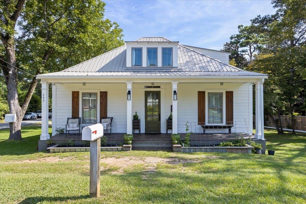 Beautifully renovated 4 bedroom 2 1/2 bathroom home with 2200 square feet of living space. This home is a must see. On main level are 3 bedrooms with a jack and jill bathroom with soaker tub as well as a half bath and walk in closet. The inviting open concept kitchen and living room are perfect to prepare meals and spend time with friends and family. Up the stairs is an 800 square foot loft with full bathroom. The back porch with privacy curtain is great for winding down after a long day. Out back a 36'x40' drive through detached garage has an unfinished 700 sq ft apartment on upper level and 2 economy rooms on lower. Both need sheetrock and paint to get your residual income flowing. Located 1/2 mile from Gordon College and 1/2 mile from the downtown square. Call Jennifer with any questions 404-392-9668.
