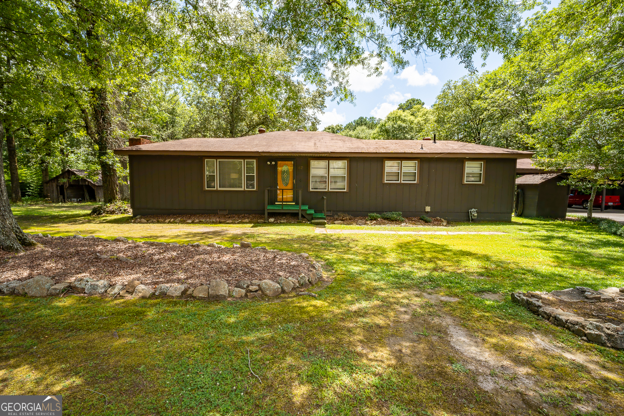 If you're looking for the perfect balance of quiet living and convenience on 2+ acres, this is the home for you! Located within the desirable Armuchee school district and just minutes from town, this charming 2 bedroom, 2 bath home offers both comfort and flexibility. Step inside to a bright eat-in kitchen that opens to the cozy living room, complete with a wood-burning fireplace-ideal for those cool Georgia evenings. The home has seen several updates and is move-in ready. All appliances stay, including the refrigerator and even a separate freezer! Outside, you'll find a three-car carport with a covered walkway leading into the home for added convenience. The property also features a workshop with electricity, two additional storage buildings (one with power), and a shed-perfect for hobbies, tools, or extra storage. But that's not all-this property includes a second residence: a well-maintained 2 bedroom, 1 bath mobile home, ideal for rental income, in-law living, or a guest house. This is a rare opportunity to own a versatile property with multiple living spaces, tons of storage, and room to grow-all while staying close to everything you need. Don't miss out-schedule your private showing today!