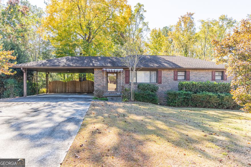 Welcome home to this charming three-bedroom, two-bath residence that perfectly blends comfort, character, and convenience. Step inside to find a warm and inviting layout featuring a spacious kitchen with a breakfast bar that opens seamlessly to the dining room; ideal for family meals and entertaining. The kitchen also offers direct access from the carport, making it easy to bring in groceries or welcome guests. Both bathrooms feature vintage tile, while the master suite includes a private bath with a shower-only design for modern ease and comfort.    Downstairs, a finished basement provides additional living or recreation space with direct entry to the covered rear patio-perfect for relaxing, grilling, or hosting gatherings year-round. From the kitchen, step out onto a large deck that overlooks a generous backyard, offering plenty of room for play, gardening, or simply enjoying the outdoors. With its thoughtful layout and inviting outdoor spaces, this home truly has something for everyone.
