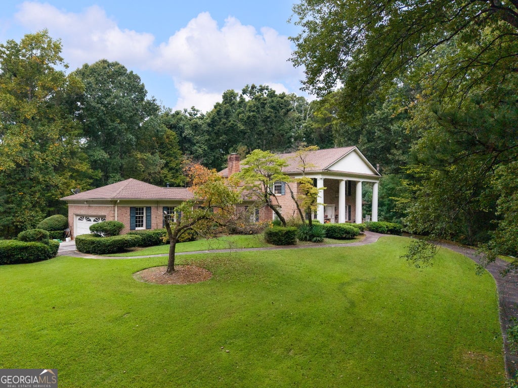 Photo of 4787 Castlewood Drive SW, Lilburn, GA 30047 (MLS # 10867403)