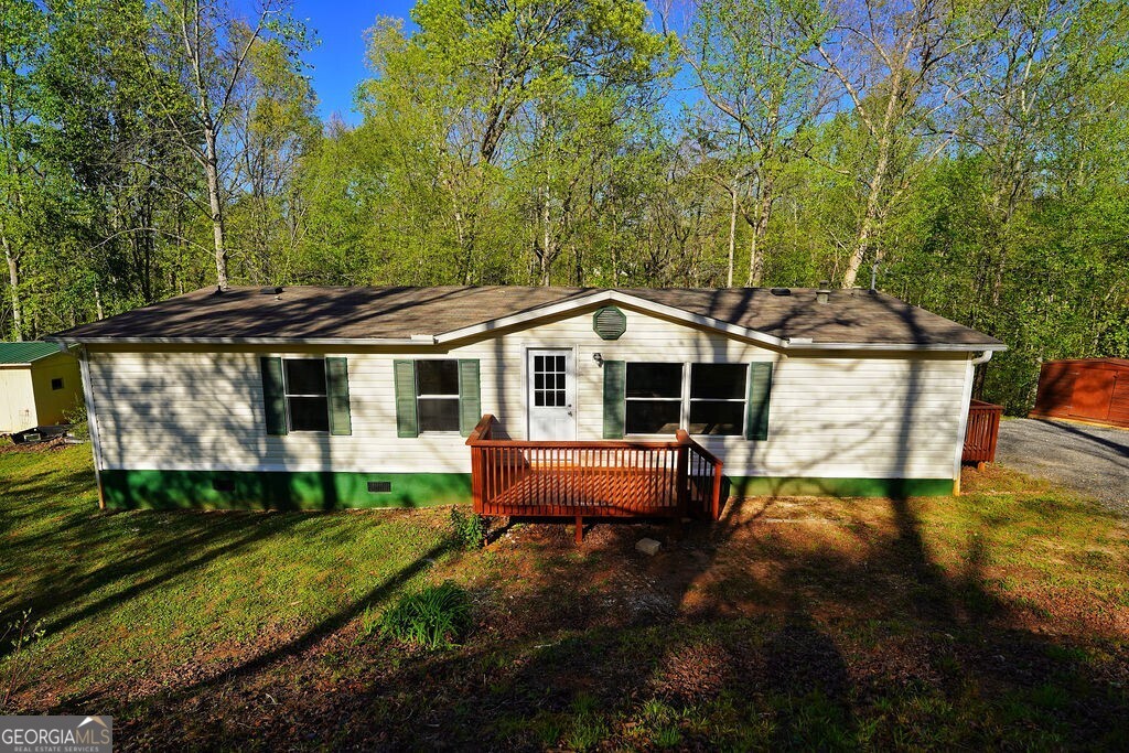 PRICE IMPROVEMENT! Completely remodeled 3 bed, 2 bath double-wide on a permanent foundation. Almost one acre, private lot. All-new, open concept kitchen with white, shaker style cabinets with soft close doors and full extension drawers. All new luxury vinyl plank throughout the home. New interior and exterior doors, lighting, interior paint, and remodeled bathrooms, as well! Huge master bedroom with sitting area, new tub/shower combo and private water closet. Separate storage shed/workshop. No builders grade anywhere you look. Seller has spared no expense updating this home! Lots of off street parking on the reworked gravel driveway. Ready for immediate occupancy. Priced for quick sale. Don't let this one get away!