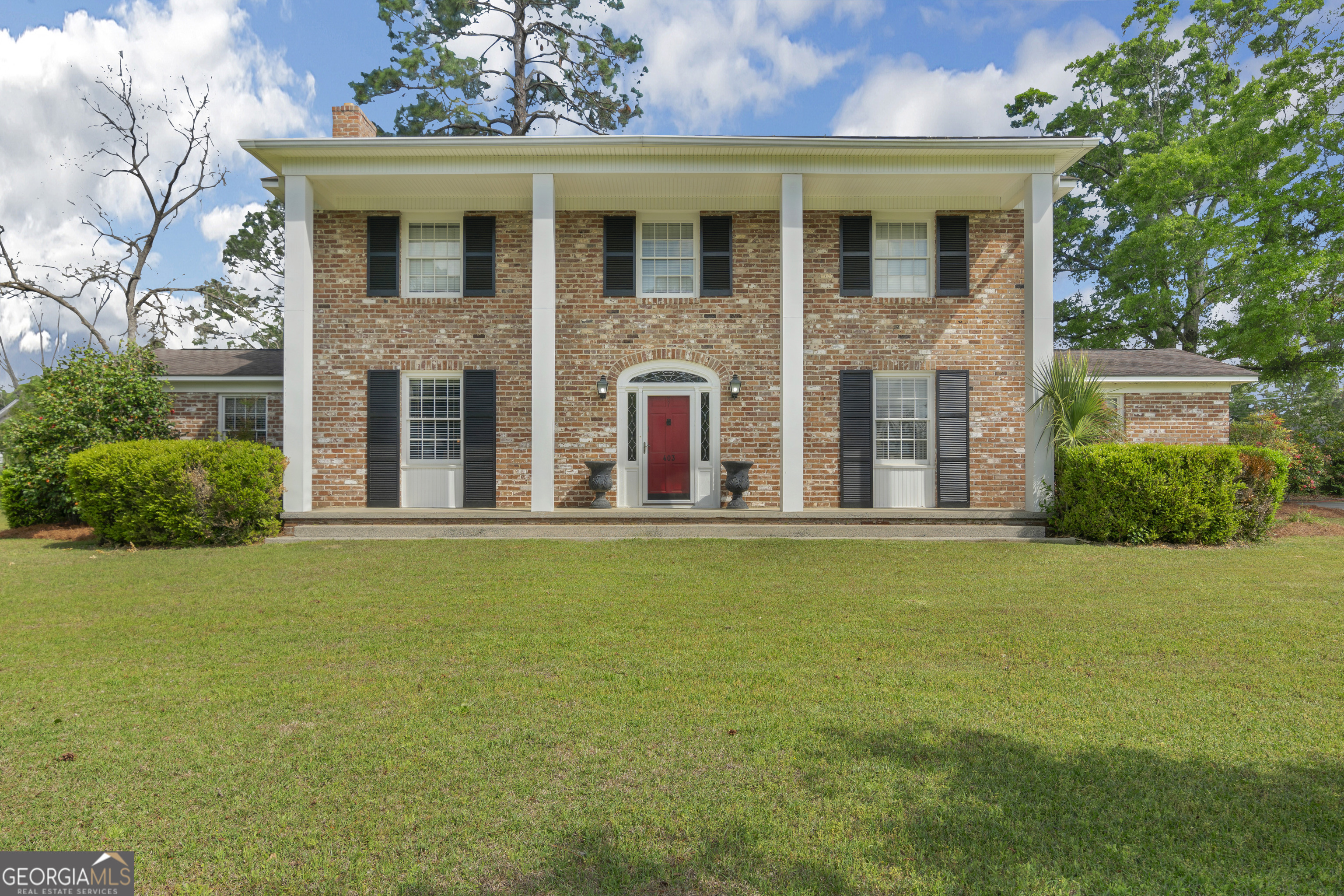 Step back in time and experience the timeless elegance of this beautifully preserved Colonial-style home, located in the peaceful and convenient town of Claxton, Georgia. This stunning residence showcases classic period details, including high ceilings, original hardwood floors, and intricate woodwork, creating a warm, inviting atmosphere that blends historic charm with modern comfort. Special features of the home include multiple fireplaces and wood stoves, perfect for cozying up during cooler nights and adding to the home's inviting ambiance. With 5 spacious bedrooms, 3.5 bathrooms, a sunroom, and a versatile den/flex room, there's plenty of room to suit every need. The meticulously cared-for kitchen is a true highlight, offering a charming eat-in breakfast area, rich wood cabinets, and newer countertops, making it a welcoming space for meal preparation and family gatherings. Sitting on a large corner lot, the home offers a covered patio ideal for outdoor entertaining or relaxing in the beautifully landscaped yard. The location provides easy access to local amenities, parks, and schools, while being conveniently situated less than 30 minutes from Statesboro, just an hour from Savannah, and 30 minutes from the Hyundai Mega Plant. Additionally, this property has a proven history as a successful Bed and Breakfast and AirBnB, offering excellent income potential if desired. Don't miss the chance to make this charming residence your own-contact your favorite Realtor today!