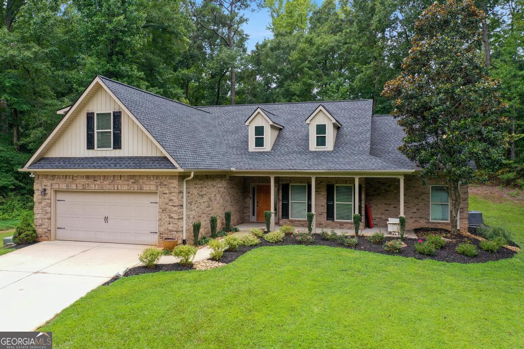 Ranch-style 4 bedroom, 2 bath home situated on 5.5 private acres with creeks on both sides of the property. Set back from the road, this home offers extra privacy and a peaceful setting. The rocking chair front porch leads into an open floor plan featuring a fireside family room, kitchen, and dining area. Hardwood floors throughout the main living areas, a split bedroom layout, and a owner's suite with a sitting area make this home both comfortable and functional. Call today to schedule your tour!