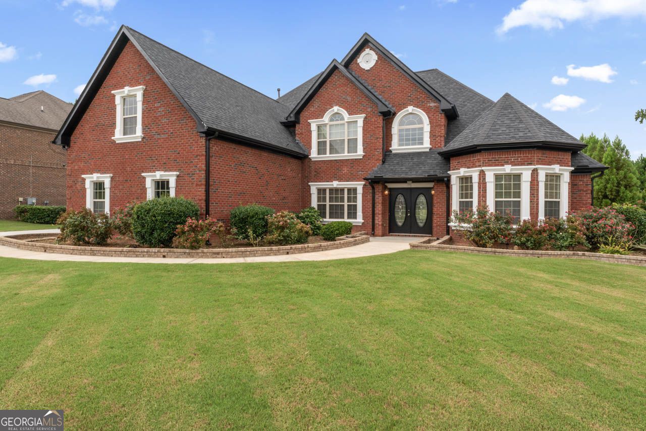 Luxurious 5BR/4BA Home in the Prestigious Crystal Lake Golf & Country Club with 2 Master Suites - Discover timeless elegance and modern comfort at 1892 Schofield Drive, a meticulously maintained 5-bedroom, 4-bathroom residence located in the highly sought-after Crystal Lake Golf & Country Club-a gated, resort-style community offering a championship golf course, serene lake views, tennis courts, swimming pools, and a private clubhouse. From the moment you enter through the grand double doors, you're welcomed by a dramatic two-story foyer filled with natural light and adorned with soaring ceilings, fresh paint, and plush new carpeting throughout. To the left, a formal dining room with beautifully detailed ceilings sets the stage for gatherings and celebrations. The thoughtfully designed floor plan features dual owner's suites, ideal for multi-generational living or hosting with ease. The main-level primary suite offers a peaceful retreat with its own fireplace, double-door entry to a spa-like bath with dual vanities, a soaking tub, separate shower, and his-and-her walk-in closets. A guest bedroom with a full bath and a spacious laundry room with cabinetry and washer/dryer access complete the main floor. At the heart of the home is a chef's kitchen equipped with granite countertops, a large center island, double ovens, gas cooktop, built-in microwave, dishwasher, and two walk-in pantries. The adjacent breakfast nook overlooks the backyard and flows into the sun-drenched family room, featuring high ceilings, a cozy fireplace, and direct access to the private patio and beautifully landscaped backyard with stepping stones-perfect for play, pets, and entertaining. Upstairs, you'll find a second luxurious master suite with a generous walk-in closet, full bath with soaking tub and shower, plus additional storage. Two additional bedrooms are connected via a stylish Jack-and-Jill bathroom with dual vanities and hallway access. A spacious hallway closet provides extra storage, while the open layout adds flexibility for a home office, playroom, or media area. Additional highlights include a 3-car garage with built-in cabinetry, kitchen sink and stove top island -ideal for outdoor cooking, catering, or a hobby space. The expansive driveway accommodates up to six vehicles, offering convenience for guests and family. Ideally located just minutes from I-75, top-rated schools, local parks, and everyday conveniences, this exceptional home combines luxury, functionality, and resort-style living in one of Hampton's most desirable gated communities