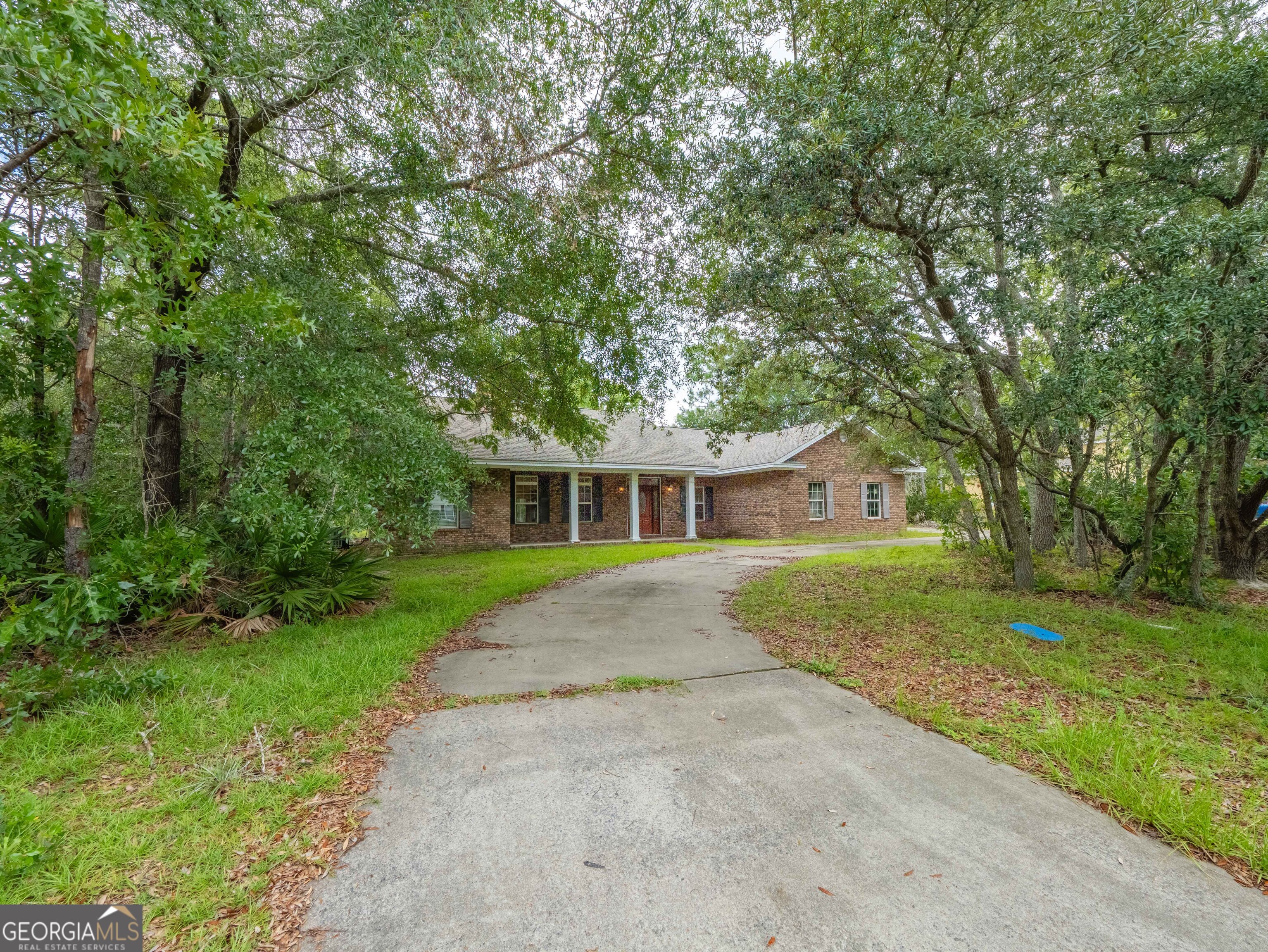This thoughtfully designed 3-bedroom, 2-bath home checks all the boxes-open concept, split floor plan, updated features, and room to live, work, and host in style. From the moment you arrive, the shaded circular drive and classic curb appeal set the tone for what's inside. Step into a freshly painted interior with brand-new carpet throughout, a bright open layout, and sizeable rooms in every direction. The heart of the home is a beautiful kitchen with a large island perfect for gathering, prepping, or entertaining. Built-in bookshelves surround the cozy fireplace-already fitted for a gas hookup-creating a warm, inviting living space. The oversized primary suite offers a true retreat, featuring a spacious bedroom and an en-suite bath that stuns with a full-width, slate-grey walk-in shower, dual shower heads, and double vanities. Two additional bedrooms-one still undergoing renovation-provide flexibility, while a bonus room offers space for a home office, playroom, or guest space. Major updates already complete include a new roof (less than a year old), a three-year-old water heater, fresh paint, and new carpeting-giving you peace of mind and move-in-ready appeal. Outside, enjoy a large backyard with a spacious patio for relaxing or entertaining, plus both an attached garage and a detached garage for extra storage or workspace. With the seller continuing to improve the home while it's listed, this property offers rare value, flexibility, and room to personalize. Priced to sell and easy to show!