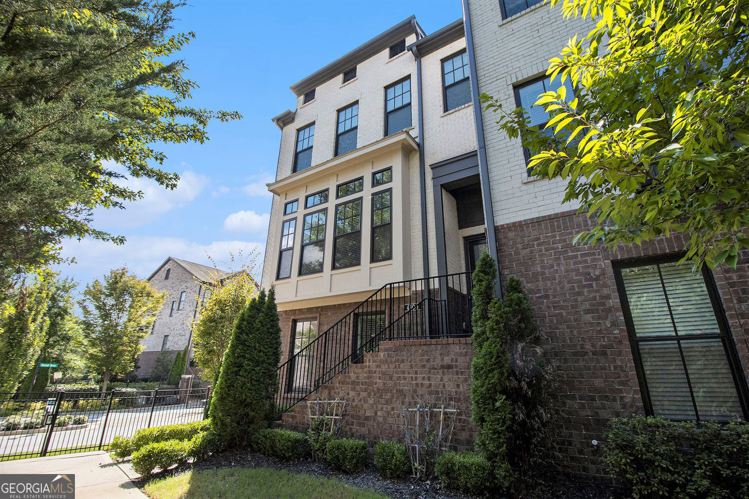 Don't miss this move-in ready (Furnished or Unfurnished) beautiful brick end-unit townhouse located in the highly sought after gated Georgetown Square community. This very spacious 4 bedroom,3 full bathrooms, plus 1 half bathroom home boasts three finely finished levels, each showcasing high-end finishes throughout. The main level area has a living room with a gas fireplace for cozy atmosphere, and open flow to a formal dining area to showcase a formal dining set. The soaring 10-foot ceilings create a great feeling of space. The area next to the kitchen has option for use as a breakfast area or a 2nd seating area with open view/flow to the kitchen for family and entertainment connections . You will enjoy the gourmet kitchen which proudly boasts quartz countertops, high-end Bosch built-in stainless steel stove, microwave/convection oven, gas cooktop, and vent hood. It has special touches like the desirable soft-close shaker cabinets for the sophisticated touch and large custom pantry. The home has engineered hardwood floors on the main level add easy to maintain durable glamour to the expansive space, stairwells, and hallways throughout the home. Bedrooms are carpeted for quiet transition to bathrooms with professionally designed lovely floors, matching shower walls and sink counters. The Upper level has three bedrooms, including a generously sized primary suite. Retreat to the primary suite with its elegant double tray ceiling and a luxurious spa styled ensuite bath featuring high quality countertops, flooring and shower, plus a spacious free-standing soaking tub, double vanity, and a 3/4 glass walled shower. You will appreciate the large walk-in close fit for all clothing from casual to fine apparel. The oversized laundry room, also on the upper level, has space for pre & post wash laundry, and optional storage shelving. The fourth oversized bedroom that can flex to serve as a gym, playroom, or home office, including private access to the third full bathroom. There is a very large storage closet that will surprise and delight you for the extra convenience it offers. The terrace level has a rear-entry garage, and entry area useful as reading nook or mudroom. There is an expansive deck on the main level off the kitchen provides easy access for grilling and entertaining with the benefit of a privacy wall and not facing the front or rear of another townhome. Relax and entertain in the community courtyard with seating. Enjoy strolls down the stone path walking trail with shade trees. Bring your on style preferences or ask for referral to an experienced professional Interior designer.