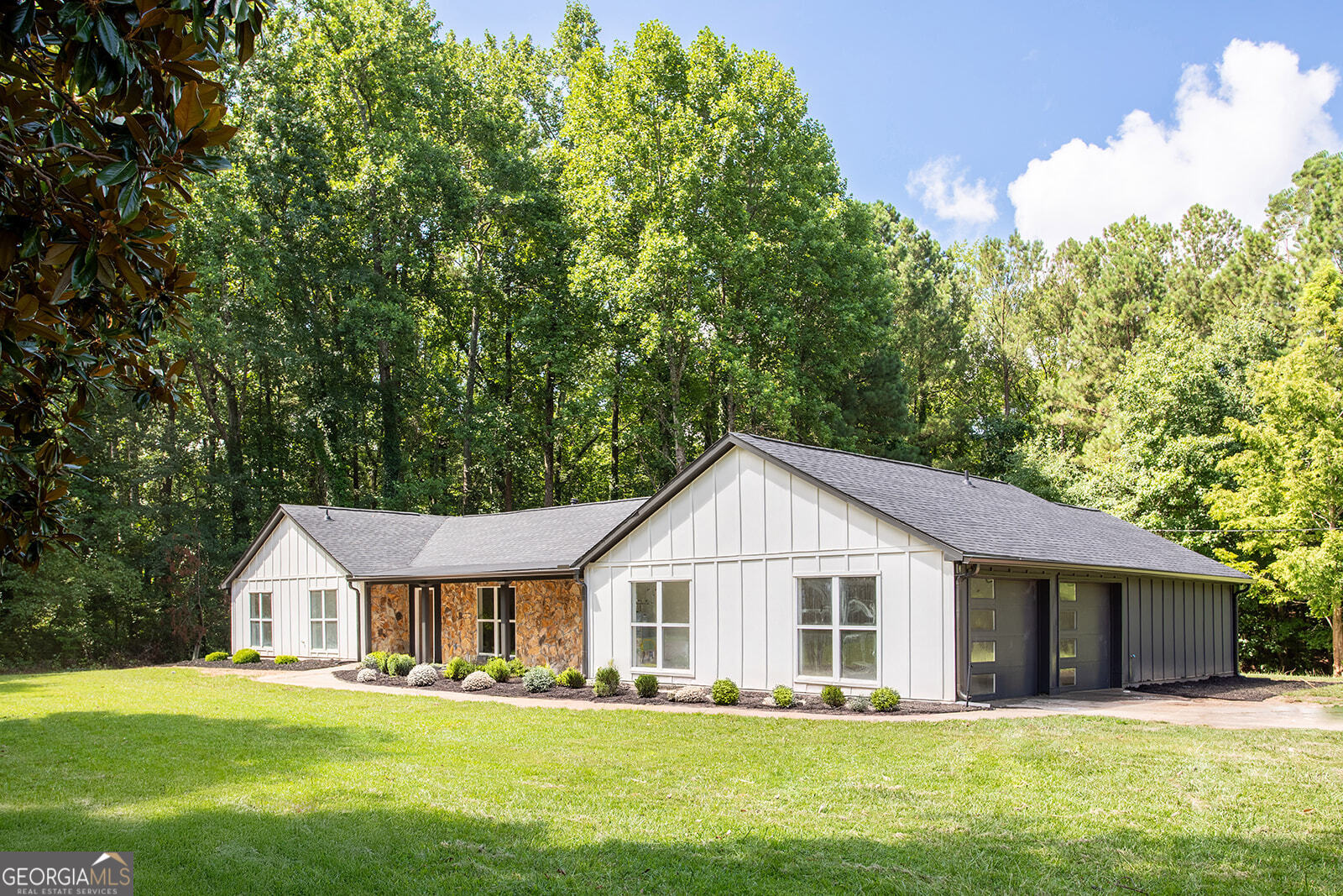 Discover the perfect blend of charm, privacy, and modern upgrades in this beautifully renovated 4-bedroom, 3-bathroom farmhouse-style ranch, complete with a bonus room ideal for a home office or flex space. Set on 1.5 private acres in Austell, this property offers no HOA and no Mableton city property taxes-delivering both lifestyle freedom and long-term savings. No detail was overlooked in the full renovation, which includes a new roof, house wrap, exterior siding, fascia, soffits, and garage door. Inside, the home features all-new sheetrock walls and ceilings, solid interior doors, high-efficiency insulation (R38 ceiling / R19 walls), and luxury flooring throughout. The heart of the home is a stunning, fully updated kitchen with shaker cabinetry, quartz countertops, and brand-new stainless steel appliances, opening to a light-filled living area anchored by a sleek electric fireplace and modern lighting. All three bathrooms have been tastefully remodeled with contemporary finishes and clean lines. Additional upgrades include a new HVAC system, smart thermostat, updated electric fixtures, and a new water heater. Outside, a freshly poured concrete patio offers the perfect setting for entertaining or relaxing in your expansive backyard. Stylish, functional, and completely move-in ready-this is the turnkey opportunity you've been waiting for. Landscaping photos are virtually enhanced.