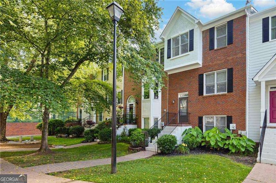Welcome to this beautifully updated townhouse located in a desirable Marietta community. From the moment you step inside, you'll notice the fresh paint and new flooring throughout. The main level offers a warm and inviting living room complete with built-in shelving and a cozy fireplace-perfect for relaxing or hosting guests. The kitchen features modern appliances and connects seamlessly to the dining area and a screened-in porch, offering a peaceful spot to enjoy your morning coffee or unwind in the evenings. Upstairs, the primary suite includes a dual vanity, a separate tub and shower, and generous closet space. The finished lower level features a full bedroom and bathroom, along with a flexible sitting room-ideal for a media room, home office, or extra storage. Enjoy the convenience of a two-car garage and take advantage of the community's amenities, including walking trails, a swimming pool, and tennis courts. Just minutes from shopping, dining, parks, and top-rated schools, this move-in ready home offers the best of Marietta living.