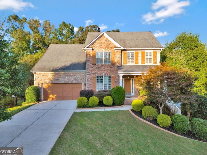 Just a short stroll or golf cart ride to vibrant Downtown Woodstock, this immaculate home is located in the highly sought-after Woodstock Knoll community-offering resort-style amenities including a clubhouse, pool, tennis courts, and playground. Zoned for top-rated schools and just minutes from I-575, this home perfectly blends small-town charm with unbeatable convenience.    Beautifully maintained and thoughtfully upgraded, this home sits on one of the largest, most level fenced lots in the neighborhood-ideal for recreation, play, and outdoor entertaining. Step inside to find an inviting open floor plan with engineered hardwood floors throughout the main level and custom plantation shutters that add timeless elegance.    A spacious dining area greets you at the entry, perfect for gatherings or flexible enough to serve as a home office or sitting area. The light-filled great room features a stacked-stone fireplace and opens to a deck overlooking the private backyard-ideal for morning coffee or weekend grilling. The designer kitchen boasts an oversized island, stainless steel appliances, and a sunny breakfast area with views of the backyard.    Just off the garage entry, there's a convenient drop zone with built-in bench and storage-the perfect spot for coats, backpacks, and everyday essentials. The garage offers a deep tandem bay providing space for three vehicles, a golf cart, or additional storage.    Upstairs, the spacious primary suite impresses with two walk-in closets, a tray ceiling, and a spa-like bath with a soaking tub and separate shower. An office nook provides a quiet workspace, while the additional bedrooms are generously sized-each easily accommodating queen-sized beds with plenty of room to spare.    The finished terrace level is the ultimate entertainment zone, featuring a billiards area, media room, full bath, and a built-in bar-perfect for movie nights or game-day gatherings. A fifth bedroom could easily be added if desired, and there's also a large storage room for convenience.    Enjoy everything Downtown Woodstock has to offer-award-winning restaurants, boutique shopping, live entertainment at the amphitheater, and miles of scenic trails-all just minutes from your door.