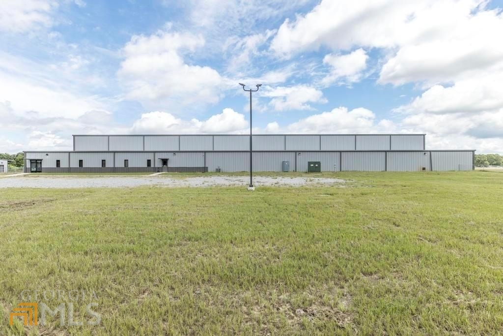 Excellent location for Light Manufacturing. BUILT IN 2020/2021 this pre-engineered steel building with 27'eave height is located on 23.38 acres. The shop space is 26,750 SF and office space is 5,000 SF with a total of 31,750 SF. Total of (4) roll-up doors. (4) 3-ton cranes travel along the metal beams. Serviced by city water. The property also has frontage along the Norfolk Southern Railroad to the north/northeast. Close proximity to I-16. Easy access to Highways 80, 29, 199 and 319. Approx 2 hours from Savannah/Atlanta.