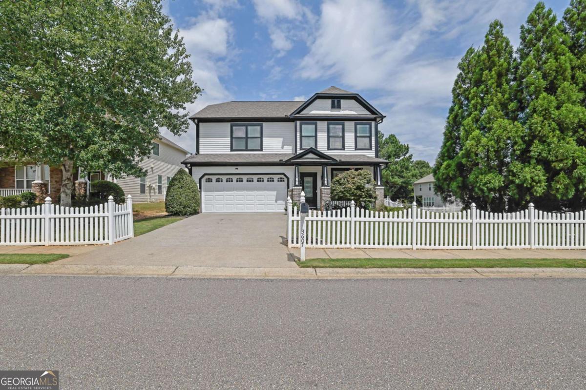 Discover Your Dream Home in a Quaint Picket Fence Neighborhood! Step into this charming 4-bedroom, 2.5-bath Craftsman-style home, bursting with character and natural light. Located in a picturesque community, this property boasts an open floor plan, perfect for entertaining. The stylish kitchen features crisp white cabinetry, sleek stainless-steel appliances, and plenty of counter space. A separate dining room offers additional space for family / friend's gatherings. Cozy up by the fireplace in the great room or unwind in the serene backyard oasis. Recent updates include a freshly painted interior, brand new exterior paint with a sleek modern look featuring crisp whites and deep blacks, new vinyl flooring, brand-new carpet, and modern lighting throughout. The spacious primary suite is a serene retreat, while the three secondary bedrooms offer comfort and flexibility. Enjoy the expansive fenced-in backyard, one of the largest in the neighborhood, perfect for relaxation or play. Please note that the lot lines extend beyond the fence. Plus, the home features a water softener system for added convenience and comfort. With convenient access to GA-400 and proximity to The Collections at Forsyth, Big Creek Greenway, and top-rated Forsyth County schools, this home offers the perfect blend of tranquility and accessibility. Schedule a showing today and make this house your home!