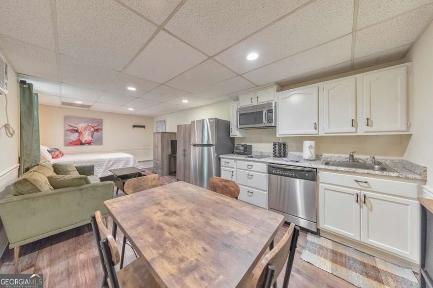 Welcome to this fully furnished studio apartment nestled in the heart of sought-after East Cobb! This basement unit offers everything you need for comfortable, low-maintenance living. The updated kitchenette features white cabinetry, an electric cooktop, microwave, dishwasher, and refrigerator. Enjoy the privacy of your own full bathroom and access to a washer and dryer located in the garage. Step outside to a beautifully landscaped backyard, where a covered patio provides the perfect spot to unwind. Utilities included in rent. One month's rent security deposit, $500 non-refundable pet fee.