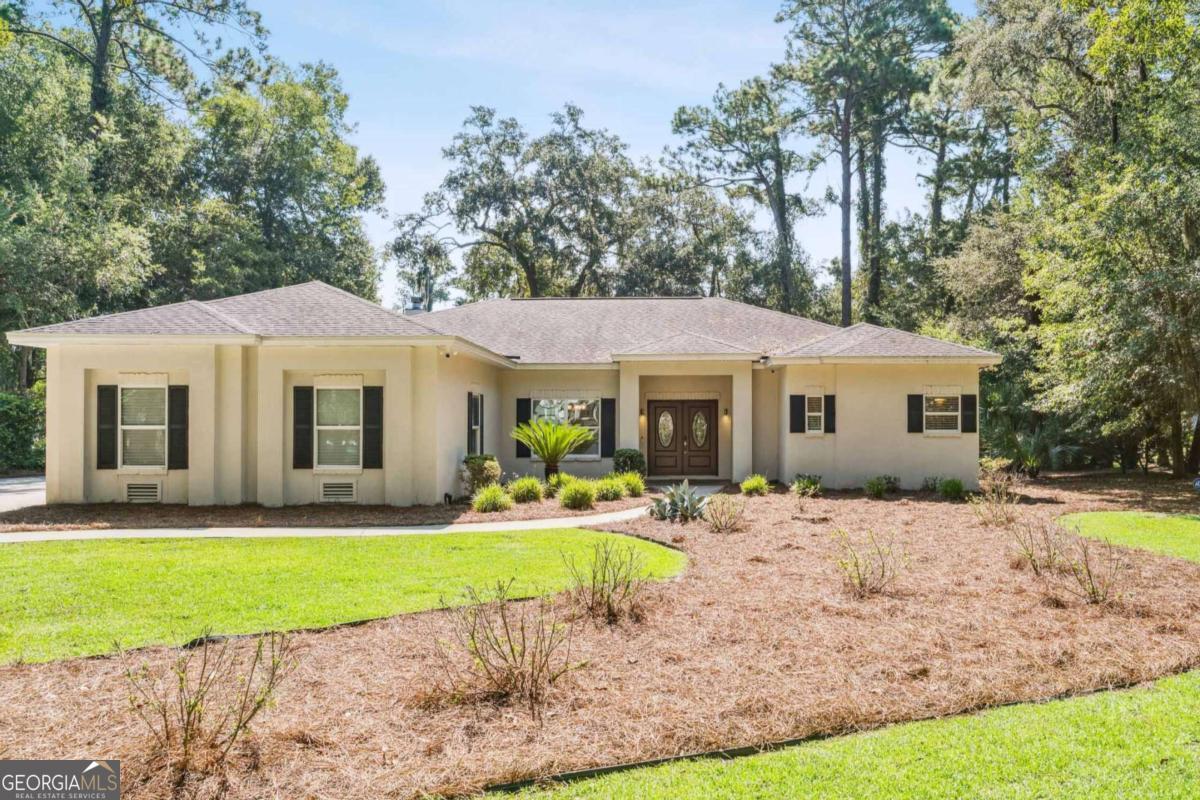 Step into timeless charm blended with modern conveniences in this beautiful home, located within the gated golf community of Hampton Plantation. Designed for comfort and privacy, each bedroom offers its own ensuite bath, complemented by a thoughtful split floor plan that allows for easy one-level living. Elegant mahogany trim runs throughout the home, adding warmth and sophistication. A dedicated office with glass French doors, spacious laundry room, oversized walk-in pantry, and a 3-car garage provide both function and style. Recent updates include fresh interior and exterior paint, a newly tiled half bath, and a tankless water heater. Outdoors, enjoy serene golf course views from the screened lanai-a perfect spot to relax and unwind. NOTE: Pre-sale home inspection conducted and areas of concerned all addressed.