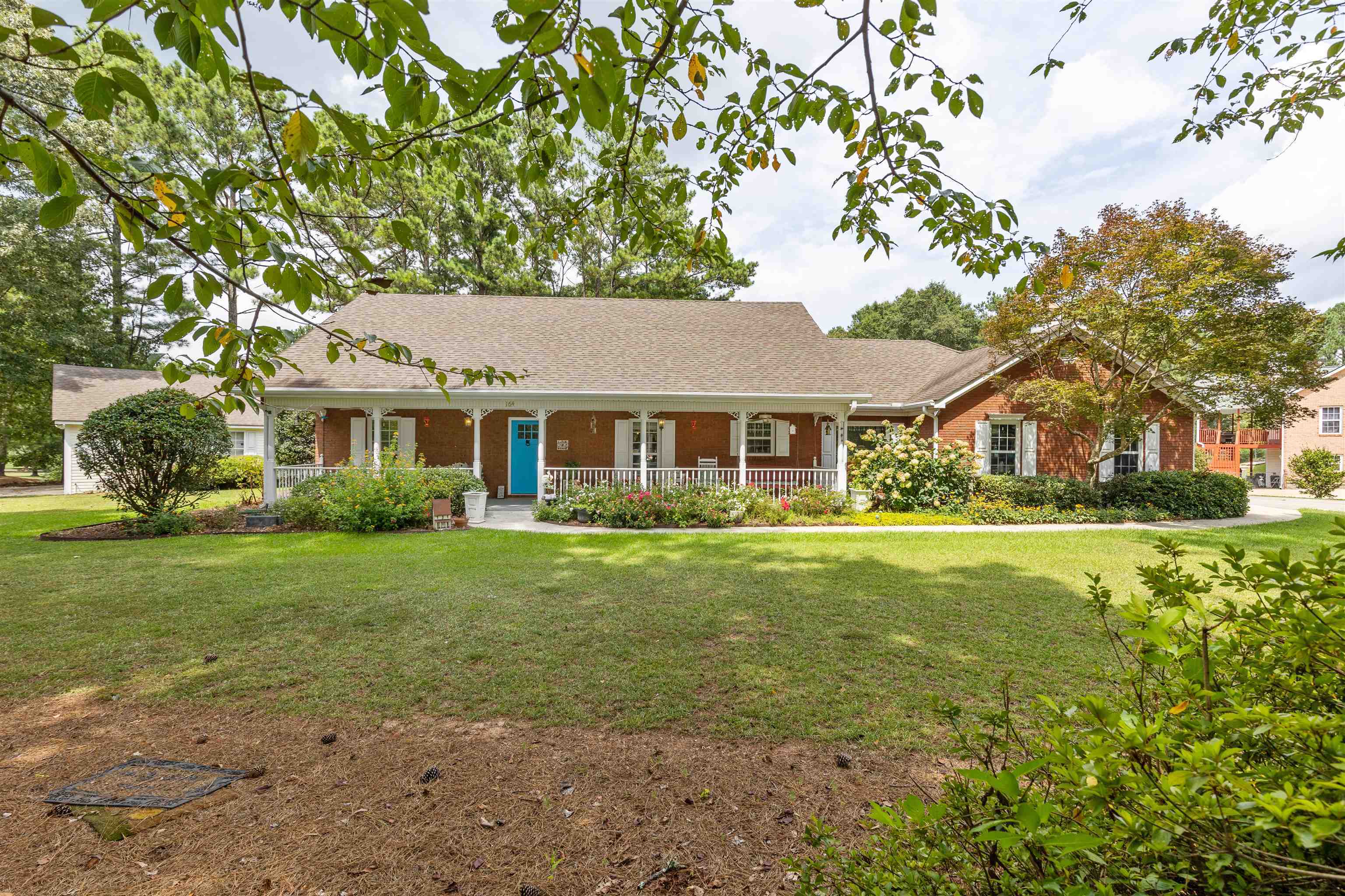 Honey, we're home! This home and neighborhood is perfect for your family. This 3 Bedroom/2 bath brick sits on the corner lot, filled with immaculate floral landscaping. The covered front porch is perfect for your morning coffee or sitting on the swing in the evening with a glass of lemonade. There is also a detached brick garage that is ready to be your new She-Shed, Man Cave, or entertainment area for family and friends. In walking distance of Hampton Middle and Hampton High Schools; perfect for the latch-key kids. You don't want to miss this! Seller to offer up to $7,000 in closing cost if buyer closes with The Clifton Law Firm, LLC , Fayetteville, GA.