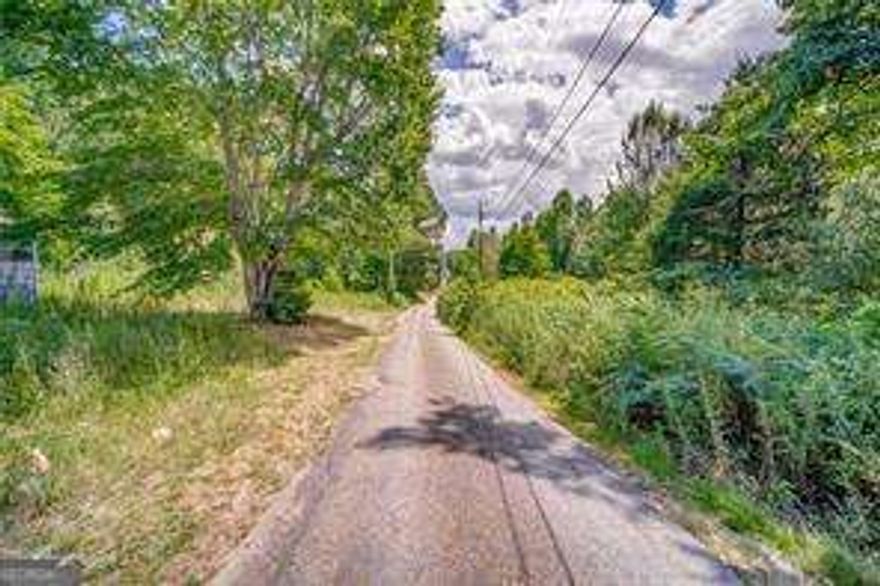This property is ready for your new build! Approximately 3 acres zoned R-40 are available for residential development - located on the back portion of the property with access from Florence Road (no road frontage on Bells Ferry Rd). Ideal for custom homes or a potential small subdivision.      Award-winning school district    Close to shopping, dining, and Allatoona Lake    Convenient to I-575 and I-75    Don't miss this unique opportunity to develop in a fast-growing area with strong residential and commercial demand!    The front 3.04-acre commercial parcel (FMLS #6990719) offers high visibility and access on Bells Ferry Road, perfect for retail, office, or service business use.