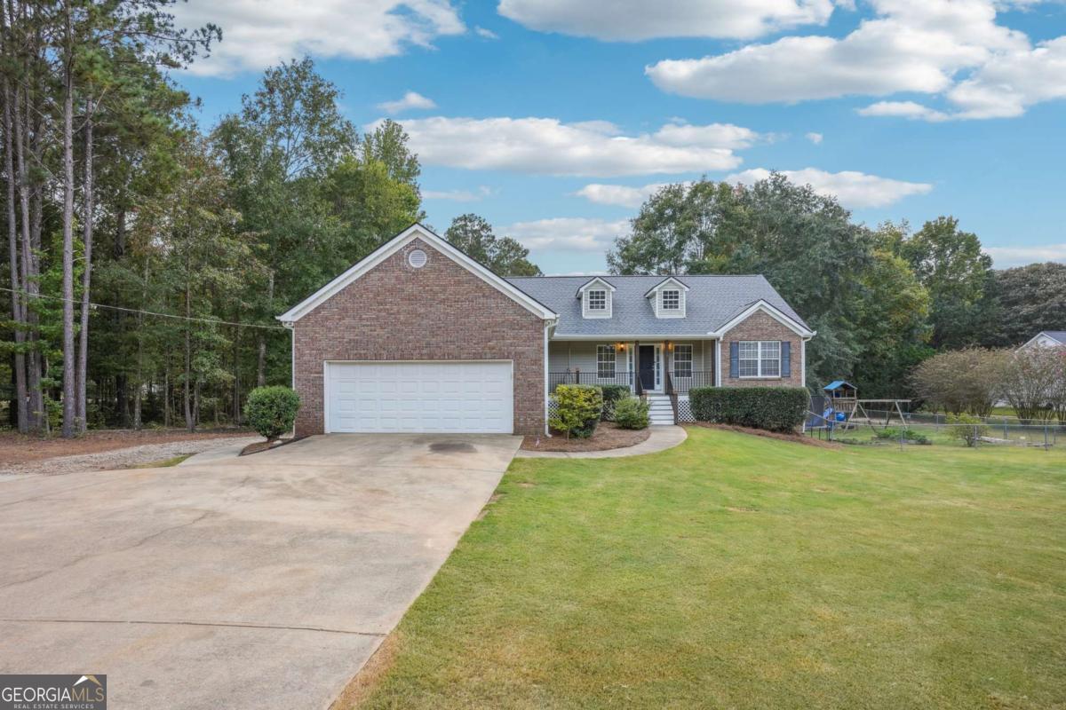 Tucked away on a tranquil 2-acre lot, this beautiful 5-bedroom, 3-bathroom home masterfully combines modern comfort with rustic charm. The spacious residence encompasses over 3,200 square feet of thoughtfully designed living space, featuring a completely renovated kitchen, a full finished basement, and a serene backyard sanctuary. At the heart of the home lies an expansive eat-in kitchen that has been meticulously updated to meet contemporary standards. The space showcases elegant white cabinetry, a convenient breakfast bar, and generous counter space that creates both functionality and style for everyday living and entertaining. The property's expansive yard creates a peaceful haven perfect for relaxation, gardening pursuits, or outdoor activities, enhanced by an automatic mower system that maintains the entire property with wired-in precision. The outdoor experience is elevated by a pristine saltwater pool, providing a resort-like atmosphere in your own backyard. For modern convenience, a Tesla charger is installed and ready for electric vehicle owners. Inside, the living room impresses with its cathedral ceilings that establish an open and airy atmosphere, while these soaring architectural elements enhance the space to feel even more expansive and welcoming. The fully finished basement represents a versatile and generous space that significantly adds both comfort and functionality to the home. This adaptable area presents endless possibilities, whether you envision creating a home theater, game room, private guest suite, or a quiet home office retreat. The property has undergone extensive professional improvements, including the removal of more than 1,000 trees and professional grading to optimize the landscape and create the perfect balance of privacy and openness. A comprehensive surveillance camera system provides peace of mind and security throughout the property. This exceptional property offers the perfect blend of luxury amenities, modern technology, and natural beauty, creating an unparalleled living experience in a private, professionally maintained setting.