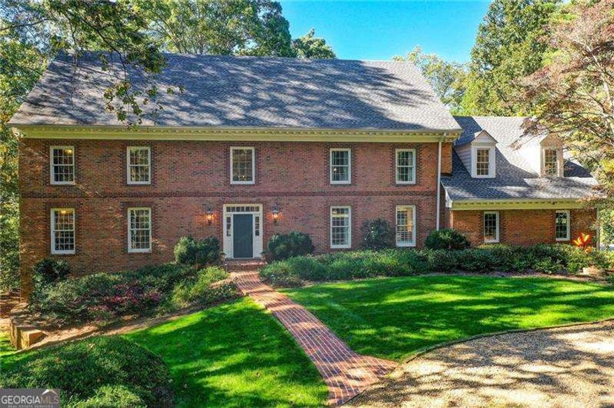 Welcome to 1710 Winterthur Close an exceptional estate on the banks of the Chattahoochee River in the prestigious Winterthur community. Nestled on 2.39 private acres, this beautifully renovated brick traditional combines timeless architecture with modern luxury. Drive up to this level, beautifully landscaped lot where a graceful circular driveway and impeccable curb appeal set the tone for the elegance that awaits inside. Offering 7 bedrooms and 5 full bathrooms, this home provides expansive spaces for both elegant entertaining and comfortable everyday living. The main Level living includes a beautiful  kitchen and keeping rom with custom stunning tongue-and-groove ceilings with beams.  This chef's  kitchen  features quartz  countertops, custom cabinetry, an 8 foot  island,, top-of-the-line Wolf, Sub-Zero  and Cove appliances. Kitchen opens to a keeping room which  has floor to ceiling windows and  a custom built-in bar and entertainment area, perfect for gatherings. The main level  living has hardwood flooring and a beautiful vaulted fireside living room,  a banquet-size dining room, and a charming sunroom with brick flooring and floor-to-ceiling windows overlooking the backyard and Chattahoochee River. The primary suite on the main level includes double closets, a dressing room, and a spacious bath. The main level also has a convenient mudroom/laundry room from the walk in garage and  a guest full bathroom.  Upstairs are four additional spacious bedrooms with great closets , including two en-suite bedrooms, along with an office/media-game room or an  adult or kid hang out room over the garage. The terrace level offers ideal space for multi-generational living or guests, with a kitchen, en-suite bedroom, bunk room, gym, and  a must see media/pool room. Enjoy resort-style amenities with a heated pool and spa, expansive patios, decks and  lawn areas designed for al fresco dining, poolside lounging, and entertaining. Situated on a quiet street  in one of Atlanta's most distinguished riverfront neighborhoods, this rare river-lot property combines privacy and convenience. Located minutes from I-75, 400, and 285, it's also close to Atlanta's top private schools and award-winning Heards Ferry and Riverwood school districts.  Just minutes from the heart of Sandy Springs with all Sandy Springs has to offer including shopping, great restaurants, City Springs, Whole Foods and  Trader Joes. Close to Buckhead, downtown and the airport. The home also includes 2  tankless water heaters,  a generator and a whole house water softener 1710 Winterthur Close  offers unparalleled privacy, natural beauty, and timeless elegance-a true must-see for those seeking luxury riverfront living. Living in Winterthur means more than owning a home-it's a lifestyle. Enjoy your own private view of the Chattahoochee River.