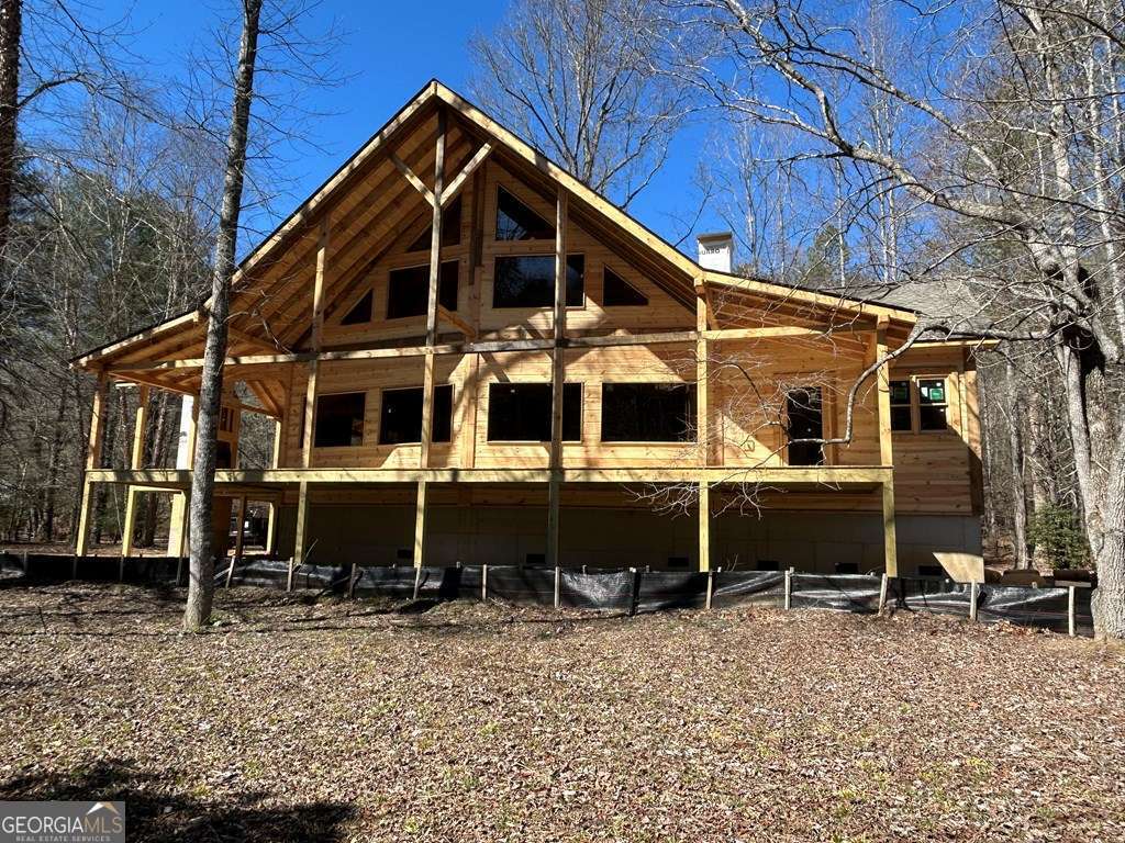 "Experience the Magic" of the Mighty Toccoa River in this BRAND NEW 4 Bdrm/4.5 Bath RIVER FRONT on a LEVEL 1.73 acre tract w/150' of a Gentle River SHORELINE. Beautiful Detailing w/Striking Features including 4 Bedrooms 4 Full Baths & a half bath for Guests.FOUR amazing BEDROOM SUITES including a spacious MAIN LEVEL MASTER, 2nd Main Level Guest Rm, 2 Upper Level Suites & an Open Loft. Wide Open Chalet elevation "frames this magnificent River" from the SO many interior vantage points in this Architectural Classic. Bring the rocking Chairs to admire this BROAD River Frontage from the Wide Covered Front Porch & Wrap Around Exterior Party Porch w/a Wood Burning Fireplace. A 3rd "Private" Covered Deck off the Master. Granite Counters, Ceramic Tile Flrs & Showers, Custom Cabinets & Hardwoods Floors are just some of the outstanding features. A prominent "Signature" Wood Burning Fireplace (w/blowers etc. ) is the focal point of the Great Rm. 3 Zones HVAC System. Interesting Elevation with a combination of Log Siding, Board & Batten and Gable Shakes. Come see what dreams are made of.