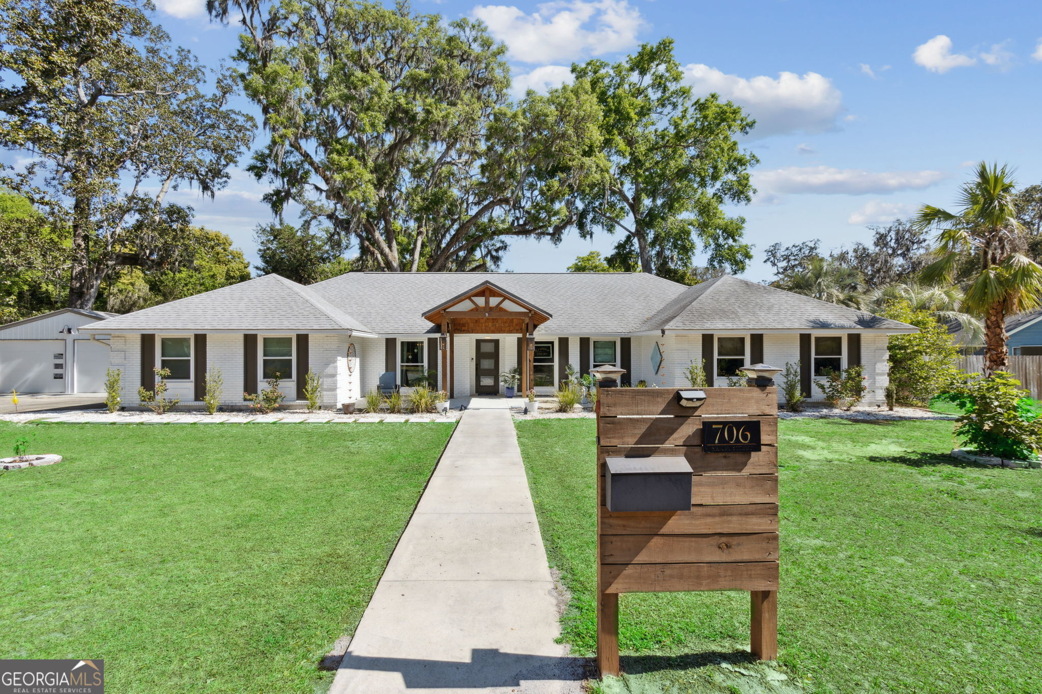 New Price Same Stunning Home! This one of a kind home offers distinctive character and features in todays market! With a thoughtful price adjustment, now is the perfect time to make this extraordinary home yours! The gorgeous home has been completely redone and renovated, and it is jaw dropping. Gas lantern sconces at the entrance welcome you to step inside. A beautiful chefs kitchen stands out with a 45 square foot quartz island and a 48"double gas oven that is sure to please anyone that loves to cook and entertain. This home is for entertaining! Lets start at the large open kitchen then to the family room with a fireplace. What a view looking through the 11 foot glass sliding doors that open up to a huge screen room (462 sq ft) where you will find plenty of areas to lounge and relax and why not sit on the hanging upholstered swing. The high ceilings are magnificent. Look out to a beautiful back yard and a gorgeous very old draping oak tree. A stunning inground salt water pool (16 x 32)to enjoy for year round use as it not only is heated but cools as well for those hot summer months. Who needs to go on vacation when its right at home!. There is a great den area inside for watching your football games and movies. A separate open dining area that captures all the beauty of the rooms and kitchen area. The primary suite feels like you are in luxury with the 35 square foot walk in shower as well as having a separate soaking tub area. Truly a haven for anyone. Large walk in closet. Big linen closet with sliding doors. There are additional two other bedrooms with another bathroom. Some of the many added features to the home include spray foam insulation in the attic, tankless hot water heater, all new electrical panel, all updated plumbing throughout, new doors and windows , gorgeous wide plank tile throughout the home. All the bathrooms have been updated, beautiful salt water pool with a lifetime liner warranty, a three car garage, large laundry room, a separate storage room, wood burning fireplace, stainless steel appliances, a wine cooler, all appliances are included with washer and dryer. Three car garage (919 sq ft) Much more to see. Bonus: No HOA fees and Not in a Flood Zone. (Zone X) Not only do you have your dream home but a dream location with the charm of coastal living perfectly nestled in a quaint downtown village. Imagine cruising on your golf cart or biking to the charming pubs and restaurants, and the ferry to Cumberland Isand just moments away. With this fantastic new price, this remarkable property now offers unbeatable value and the coastal lifestyle you've been dreaming of. Don't miss out schedule your tour today!