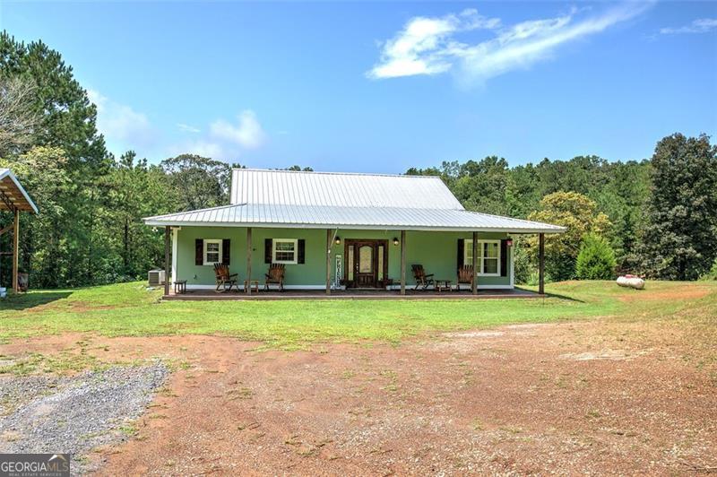 Two Incredible Homes, One Perfect Opportunity! Discover nearly 10 acres of beauty and potential with not one-but two unique homes being sold together, making this the perfect retreat for a large family, multigenerational living, or those seeking space to grow. The Barndominium (5.12 acres): Custom built just 6 years ago, this stunning 3-bedroom, 2-bath home was designed to impress. Step inside and fall in love with the spacious kitchen featuring granite countertops, stainless steel appliances, and a large island perfect for gatherings. Hardwood floors, tongue-and-groove ceilings, and generous bedrooms and baths create warmth and character throughout. Outside, enjoy a spring-fed pond, covered parking, and a massive 40x60 outbuilding with its own driveway-ideal for RV storage, business use, or a workshop. The Ranch Home (4.88 acres): Perched high above Milligan Creek, this charming 3-bedroom, 2-bath ranch offers breathtaking views of both creek and countryside. The highlight is the expansive 40x50 deck, where mornings and evenings are meant for taking in the peaceful surroundings. Inside, enjoy granite countertops, stainless appliances, hardwood flooring, and cozy carpeted bedrooms-combining comfort and elegance. Together, these properties offer: Nearly 10 acres of level and scenic land Two beautifully maintained homes with modern finishes Endless possibilities for family, recreation, or business use Whether you're looking for a family compound, a private retreat, or a place where memories will be built for generations, these properties have it all. The only thing missing is you and your vision!