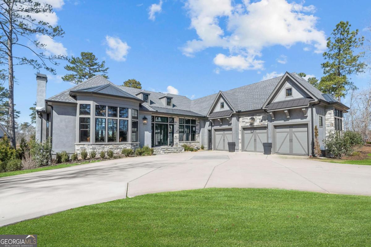 LUXURY LAKE ACCESS HOME IN REYNOLDS LAKE OCONEE - YOUR DREAM RETREAT AWAITS!!Discover the epitome of lakeside living in this stunning 5-bedroom, 5-bathroom home, perfectly situated for both relaxation and entertainment. With an open floorplan and breathtaking lake views, this beautifully furnished designer residence is move-in ready and being sold fully furnished! Step inside to find thoughtfully designed spaces that exude elegance and comfort. The gourmet kitchen is a chef's delight, featuring 12-foot cabinetry and a sprawling quartz island, ideal for hosting family and friends. The open layout seamlessly connects to the screened-in porch, complete with a cozy fireplace and an outdoor kitchen, perfect for al fresco dining. Retreat to the spacious primary master suite, where you can wake up to serene lake views and access your private back deck. The luxurious master bathroom boasts a glass shower, a relaxing garden tub, and double vanity sinks for added convenience. For entertaining, the charming bourbon room with its own fireplace provides a warm gathering spot or can easily serve as an additional bedroom for guests. The lower level offers three additional guest bedrooms, a large playroom with built-in bunks for the kids, and a generous living room area featuring a wet bar and space for an extra chef's kitchen. Step outside to your private oasis, where a large swimming pool, spa, and gas firepit await. Enjoy magical sunsets with a glass of wine in hand as you stroll down to the docks for a scenic boat ride. Don't miss out on this exceptional opportunity to own a luxury lake access home in Reynolds Lake Oconee. Call today for your private showing and experience the ultimate in lakeside living!
