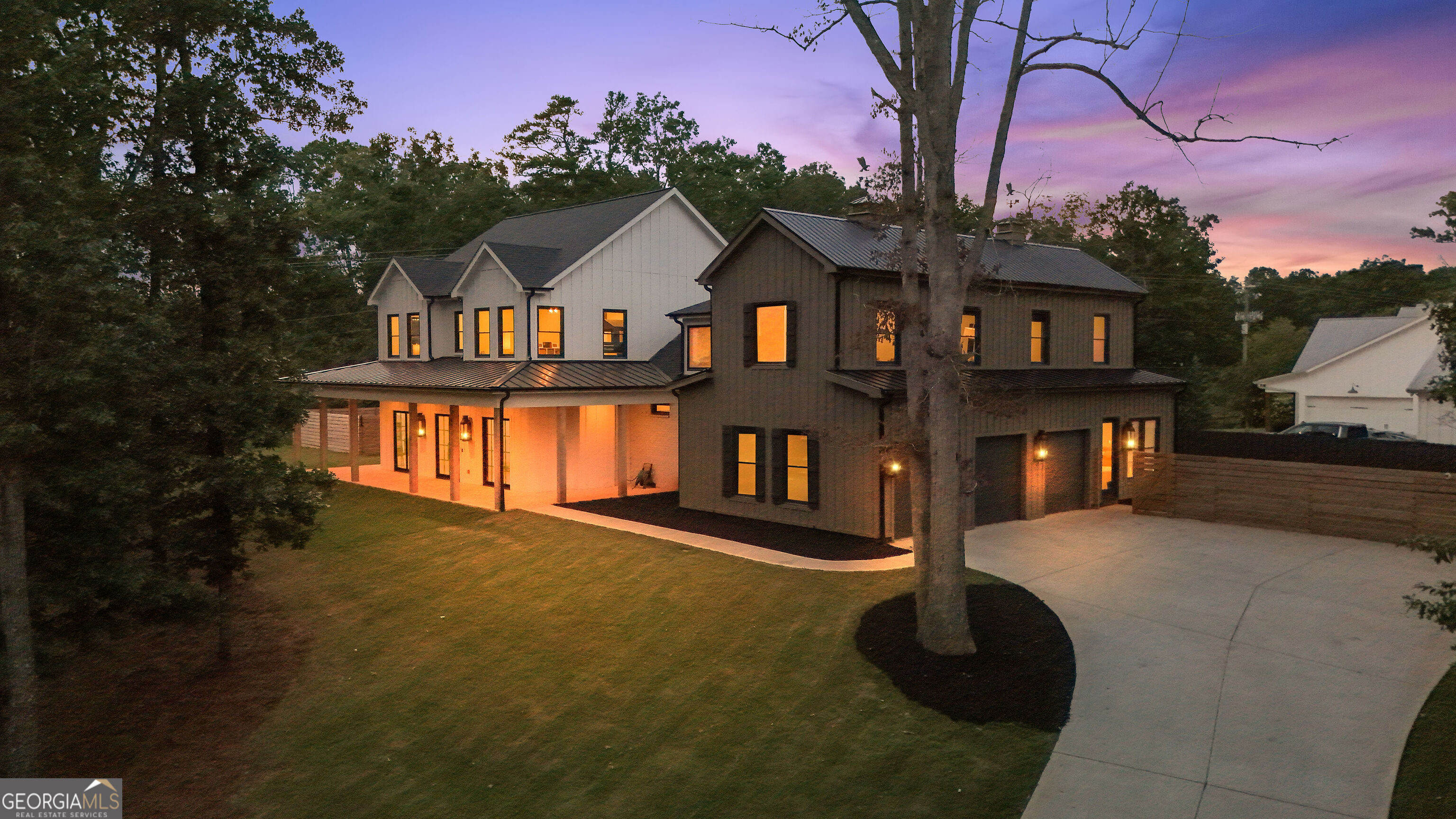 Looking for your own Oasis? This 5 Bedroom 5.5 Bathroom custom luxury home blends farmhouse warmth with European modern design inside and out. From the moment you arrive, the massive wraparound covered porch with gas lanterns, swing, and three sets of 8' custom iron doors set the tone. Inside, 8" European white oak hardwoods flow throughout. The dining room stands out with built-in cabinetry, textured wallpaper, and custom lighting, while the office offers a brick accent wall, abundant natural light, and a generous closet. The great room features a soaring fireplace finished in Italian porcelain up to the vaulted ceiling, a rustic wood mantle, and oversized windows. The gourmet kitchen is both striking and functional, highlighted by French medicine cabinets, Italian porcelain backsplash to the ceiling, and premium Smeg range and double oven. The oversized quartz waterfall island includes a composite sink and industrial Delta faucet. A separate butler's prep area adds leathered granite, beverage fridge, brick accent wall, and connects to a spacious walk-in pantry with wood shelving. Convenience continues with a laundry/mudroom attached to the 3+ car garage, featuring stone and butcher block counters, custom porcelain drop zone, and extra cabinets. This wing also includes a private guest suite with a full bath, perfect for visitors or a second office. The primary suite offers a true retreat with a dual rainhead porcelain shower, soaking tub, oversized floor tiles, dual vanities, and a massive walk-in closet. Upstairs are three additional bedrooms, a custom bath with oversized glass shower and dual vanities, plus two hidden rooms behind moving shelves, one serving as a tech hub and the other as a secret playroom. Over the garage, a private stairway leads to a huge flex space with a full bath, ideal as a media room, gym, rec room, or in-law suite. Step outside to a covered patio with a full outdoor kitchen, built-in grill by BBQ Boys, vent hood, and stone prep counters. An outdoor fireplace with TV mount makes it an all-season space. Beyond, the heated saltwater pool and spa with privacy fencing create a backyard oasis. Additional highlights include custom lighting and fans, tankless water heaters, three HVAC systems, built-in Sonos, low-voltage wiring, whole-house tech package, and attic storage. The oversized garage easily accommodates a boat, motorcycles, or ATVs. With Easy Access to HWY 400, Lake Lanier, Dawsonville Outelts, and The Cumming City Center, its no wonder why this home is The Perfect Oasis you have been looking for.