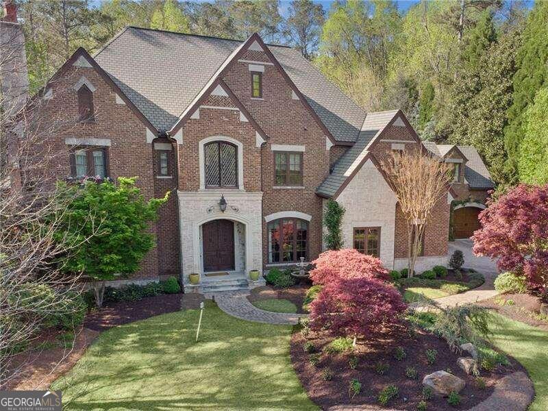 Welcome home to this truly stunning home set on 1.6 acres in Sandy Springs most sought after neighborhood of Londonberry Estates. This custom-built masterpiece is a blend of luxury and functionality, with meticulous craftsmanship and every amenity you could dream of. As you step inside, you are immediately greeted by soaring 11-foot ceilings on the main floor, with arched doorways, expansive windows, and exposed beams that create an inviting, open atmosphere throughout. Ideal for entertaining, the formal living and dining rooms are generously sized and complemented by a convenient butler's pantry just off the foyer. The heart of the home is the chef-inspired kitchen, designed with ample counter and cabinet space, and featuring a vast keeping room with a fireplace that serves as the perfect spot for family gatherings or casual relaxation. The thoughtfully designed floorplan offers a private owners suite on the main level, complete with a serene, covered porch overlooking the breathtaking backyard is a peaceful retreat in itself. The secondary bedrooms are equally impressive in both size and design, providing ultimate comfort and privacy for family and guests. Venture downstairs to the phenomenal terrace level, where you'll find an entertainers dream: a stunning 600-bottle wine cellar, billiard room, media room, spa/gym, and a custom bar with a glass-front cabinets are perfect for hosting unforgettable gatherings. Step outside to your personal backyard oasis, where tranquility and recreation meet. Enjoy a sparkling lagoon pool with waterfall and a slide, a professional-grade putting green, and a sports court. Every detail in this home exudes sophistication, from the custom walnut doors and cabinetry by Design Galleria to the gorgeous hardwood floors, and every corner has been thoughtfully designed for luxury living. Additional features include a 4-car garage, a whole-house generator, a well for irrigation, and a state-of-the-art Crestron Home control system. Situated in a sought-after school district, homes of this size and caliber rarely come available. Seize this extraordinary opportunity to live in a home where elegance, comfort, and privacy are unparalleled.