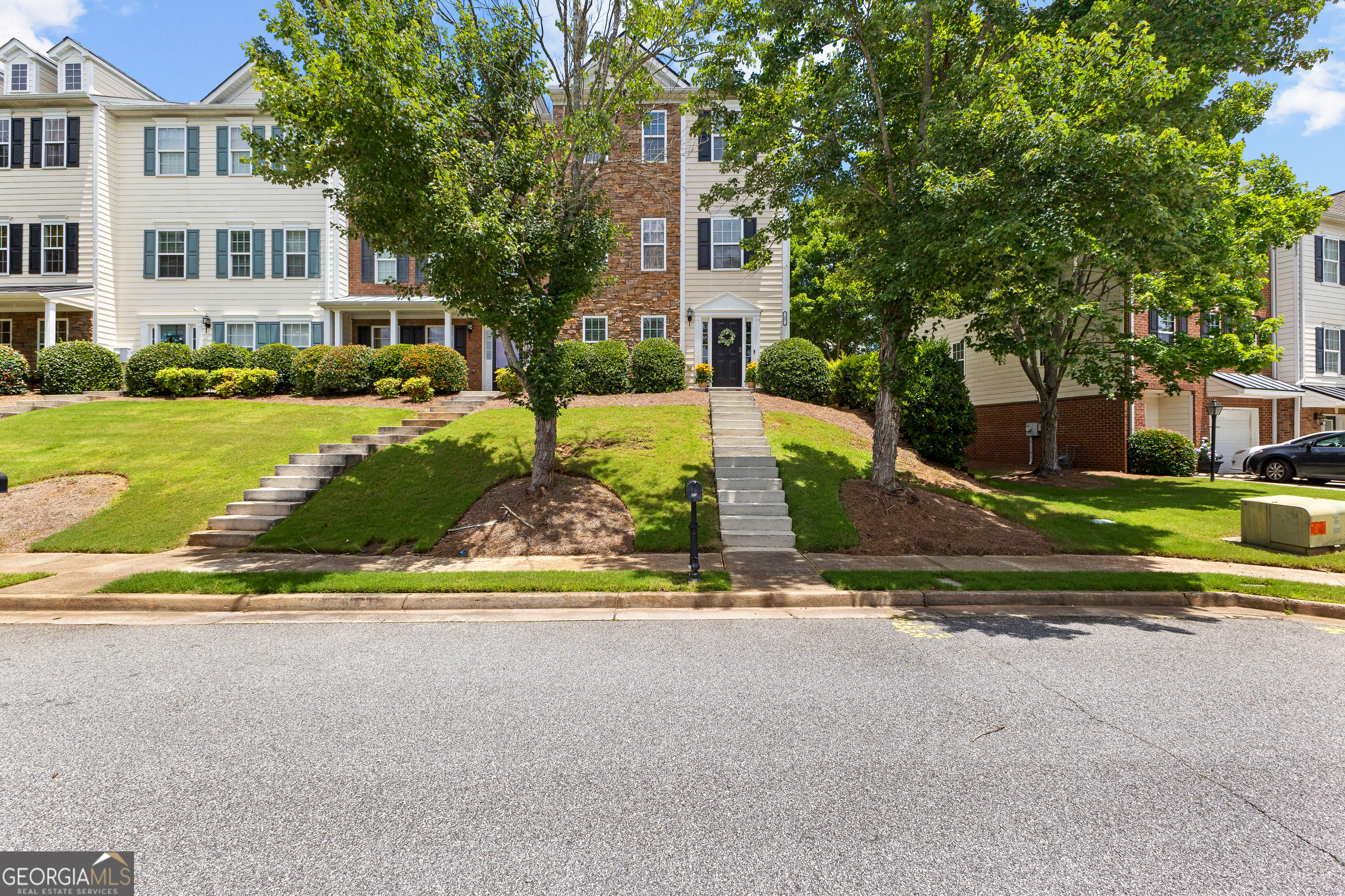 Meticulously Maintained & Fully Furnished End Unit in Summer Grove! Step into effortless living in this pristine 3-bedroom, 4-bath townhome offering access to incredible community amenities including pool, tennis courts, playgrounds, walking paths, a scenic lake, and peaceful docks. This light-filled end unit features a light filled foyer, a spacious back deck perfect for entertaining, just off the dining room and kitchen. The eat-in kitchen boasts like-new stainless steel appliances, a charming bay window, and ample pantry space. Enjoy relaxing evenings in the oversized living room centered around a cozy fireplace. Upstairs, the owner's suite features two walk-in closets and a generous en-suite bath with double vanities. A secondary bedroom offers privacy with its own full bath, ideal for guests or family. Third bedroom or office with bath on main, along with a full two car garage! Don't miss the opportunity to own a turn-key home in one of Newnan's most sought-after communities. Schedule your private showing today!