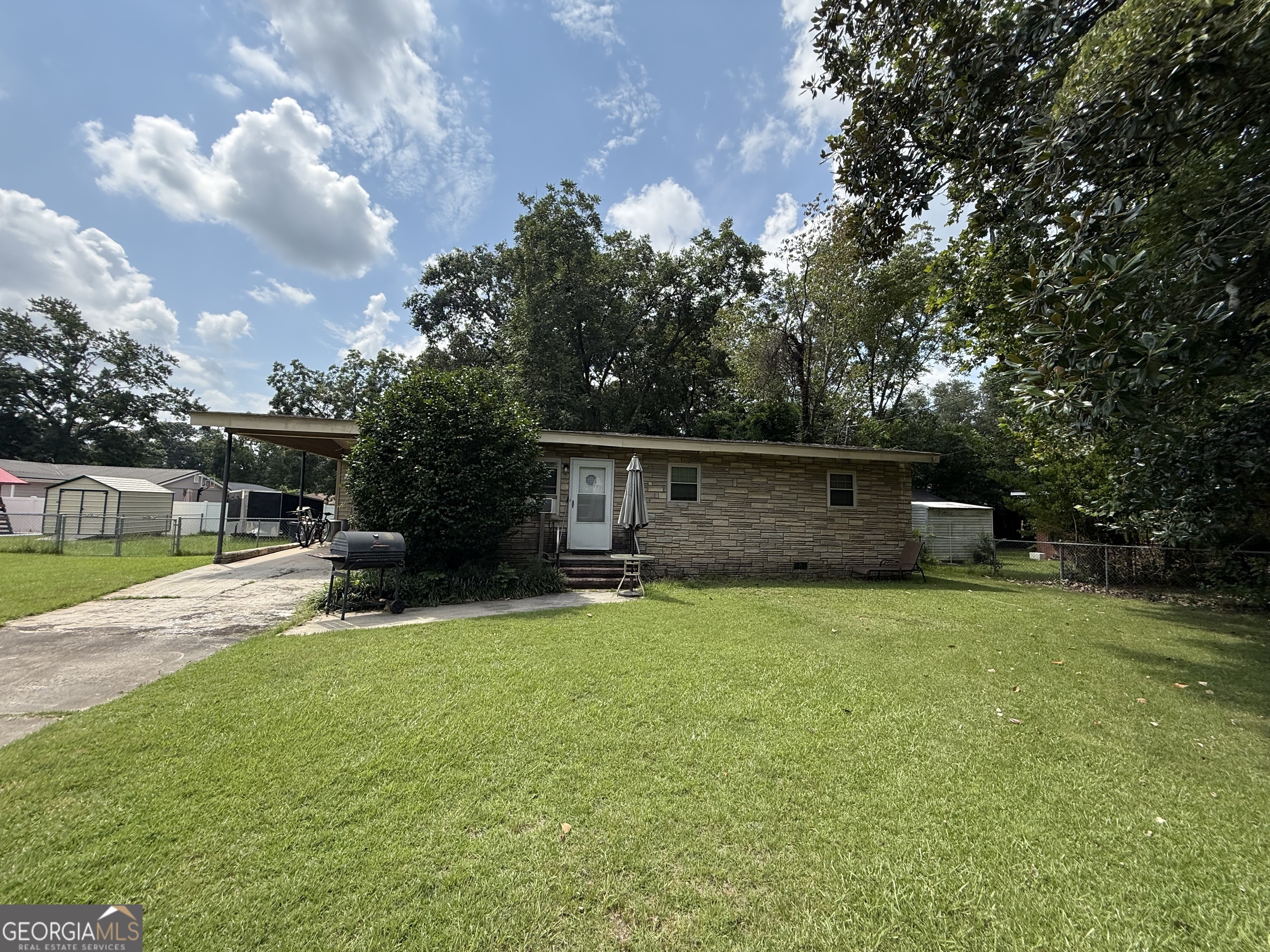 Charming single-family ranch-style home with endless potential! This property features a nice yard, perfect for gardening or outdoor activities, and a convenient carport for covered parking. Inside, you'll find a comfortable living room ready for your personal touch. A great opportunity for first-time buyers, investors, or anyone looking to make this home their own!