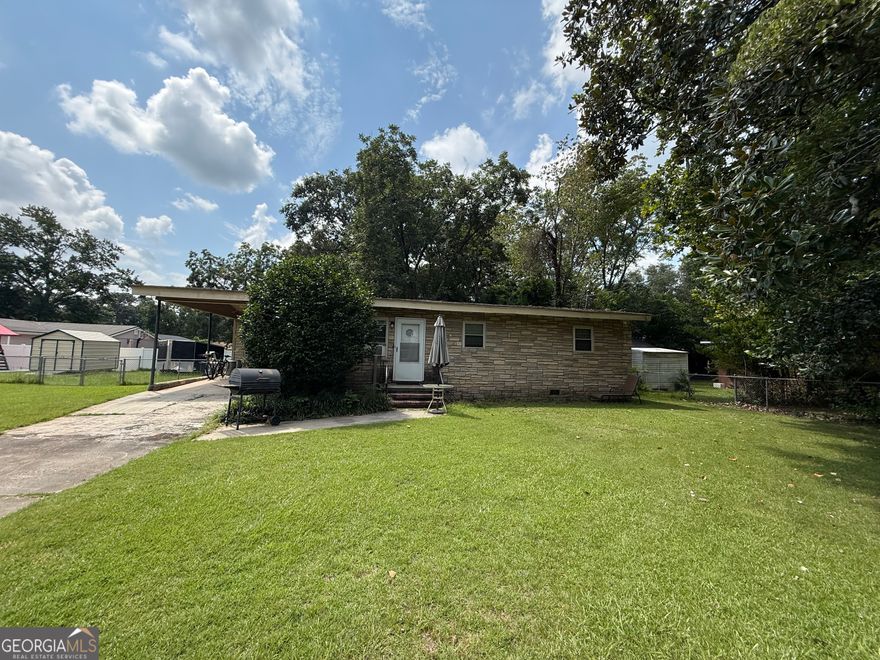 Charming single-family ranch-style home with endless potential! This property features a nice yard, perfect for gardening or outdoor activities, and a convenient carport for covered parking. Inside, you'll find a comfortable living room ready for your personal touch. A great opportunity for first-time buyers, investors, or anyone looking to make this home their own!