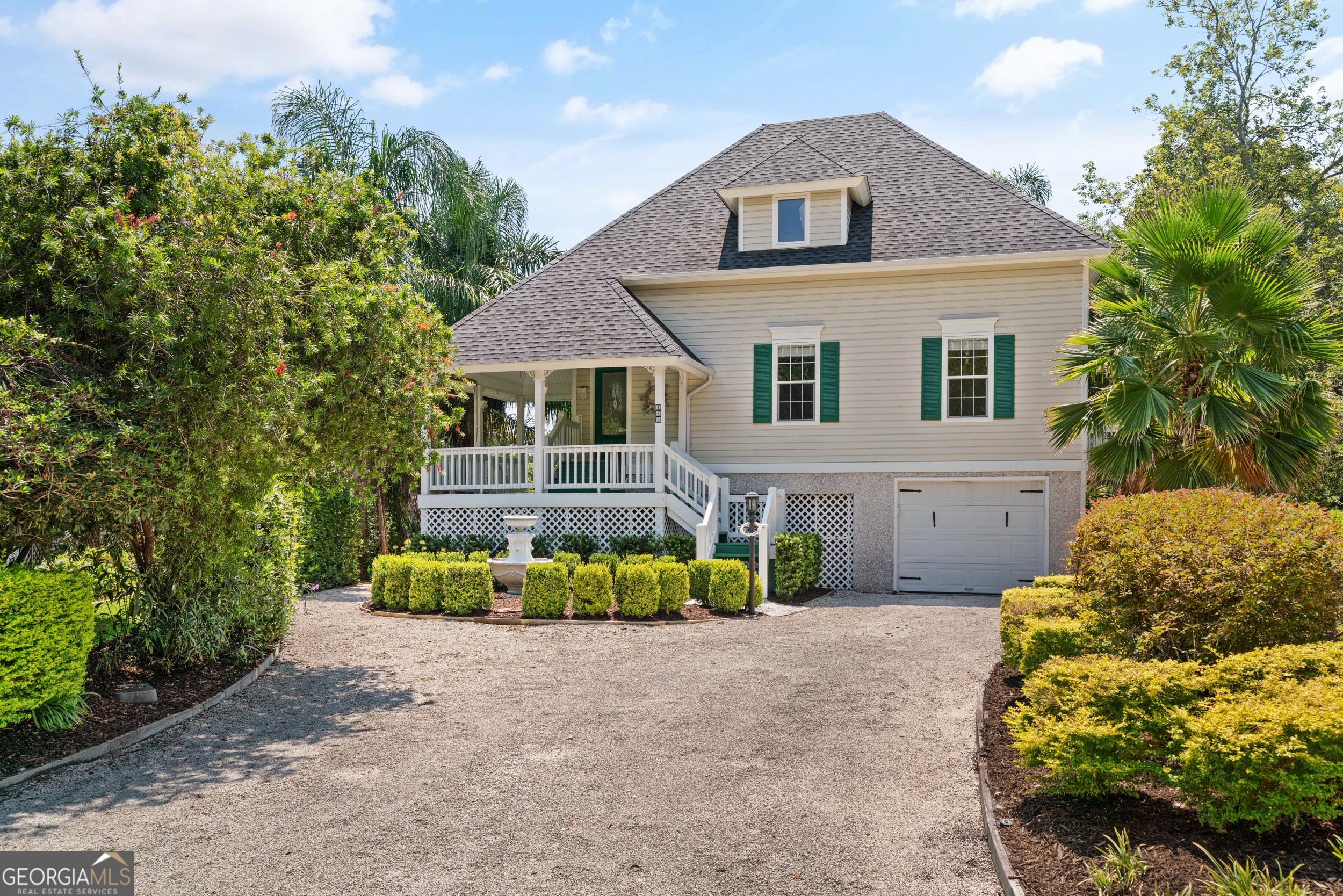 Just Listed - A South Island Sanctuary in Grand Oaks. Tucked away in the highly sought-after south end of St. Simons Island, this tropical retreat rests on one of the most beautiful lots in Grand Oaks - just a mile from the beach and moments from Pier Village, the lighthouse, and all the island charm you love. From the moment you step inside, vaulted ceilings and warm wood floors welcome you into a light-filled great room anchored by a cozy wood-burning fireplace. French doors open to a sweeping wraparound porch where gentle breezes carry the sound of the pond's fountain. The kitchen is as inviting as it is functional, with stainless steel appliances, granite countertops, and French doors leading to your outdoor living spaces. Two comfortable bedrooms share the main level, while the top floor is devoted entirely to an expansive primary suite - complete with a generous walk-in closet and a spa-like bath with an oversized shower. Wraparound covered porches and screened porch invite morning coffee and sunset conversations, all with serene water views. Below, you'll find abundant storage, including a large enclosed room, plus the peace of mind of a Generac whole-house generator. The primary level features two bedrooms that share a full bath. The entire top floor is a primary suite with large walk-in closets and a beautiful bathroom with a spacious shower. Located in a quiet neighborhood with no short-term rentals allowed, this is the perfect haven for those seeking privacy, beauty, and an authentic island lifestyle.