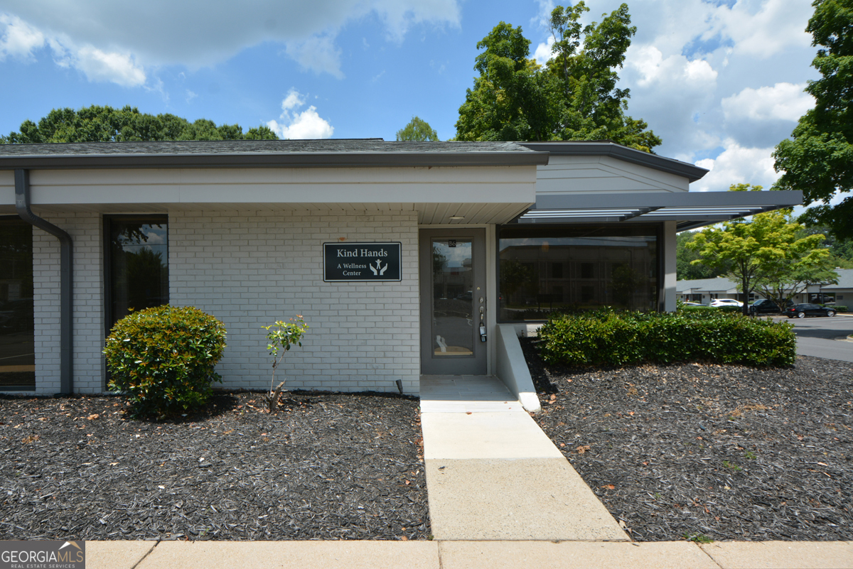 Available for Lease in North Fulton Executive Square Office Park located off Houze Way in Roswell next to Roswell Bicycles and across the street from new Tolbert Yilmaz Dance School. This Newly Remodeled End Unit is ideally located within the office park and features a Large Front Display Window wrapping the corner of the building. The 964 sq. feet layout includes 4 Private Rooms, each featuring a Floor-to-Ceiling Window for abundant natural light. One of the Private Rooms is spacious enough to accommodate a Conference Table, making it ideal for meetings or collaborative work. This unit also features a Private Front Entrance, dedicated Reception Area and Restroom. A breakroom with sink, microwave and refrigerator. and a built-in cabinet with countertop offers versatile space for a coffee station. A large closet area can be used for additional storage, seating or equipment. Upgrades include Modern LVP Flooring, and Fresh Paint. New Exterior upgrades include Fresh Paint, New Siding, updated Landscaping, Brand-New Roof, and fully Repaved Parking Lot completed in 2024. The professional curb appeal is sure to impress both clients and prospective tenants! Located in the highly desirable North Fulton Executive Square Office Park at the corner of Houze Way and Houze Road, perfect for your business. Rent Includes: Trash, Water and Exterior Maintenance. Tenant responsible for Gas, Electric, and Cable/Internet.