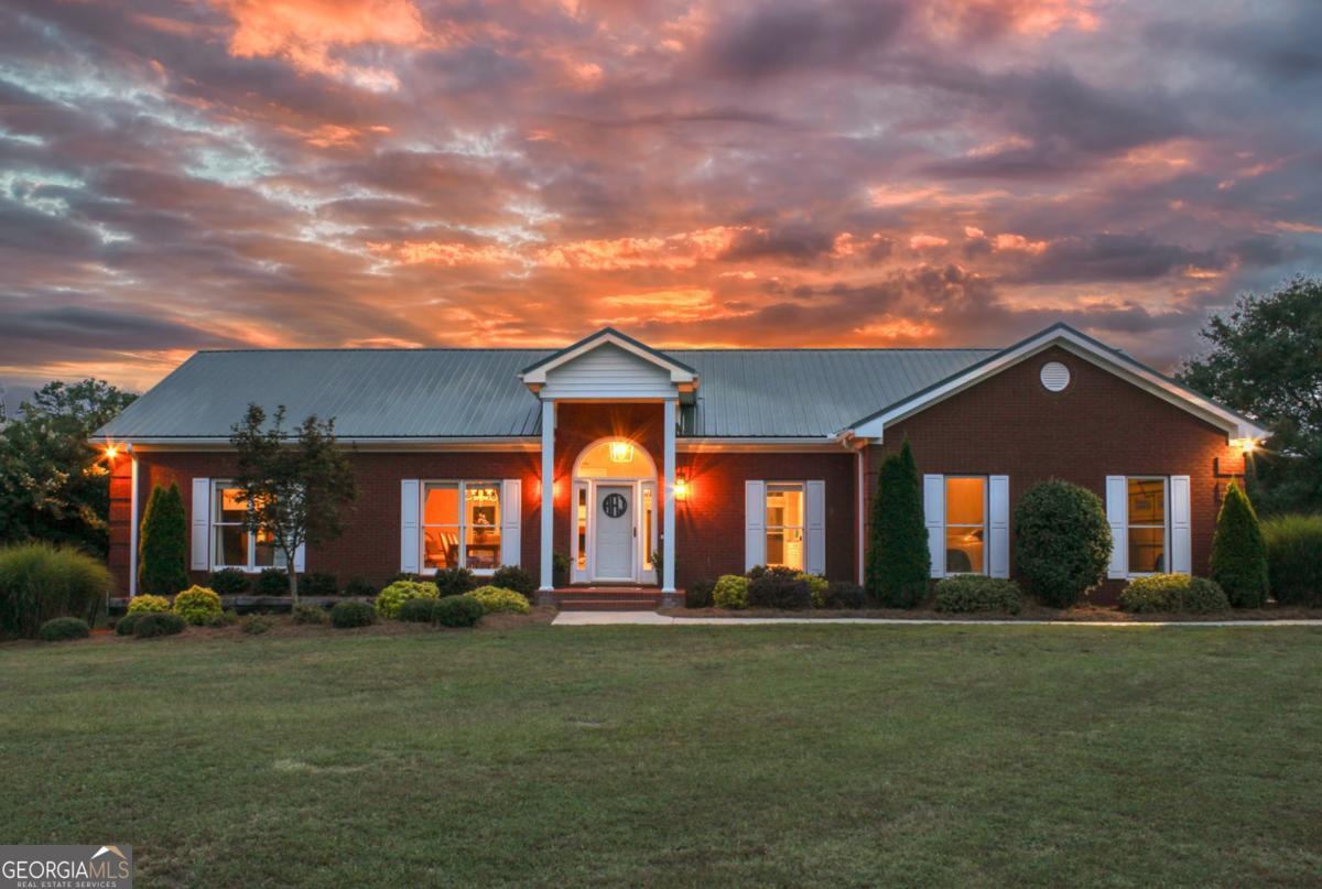 Welcome to 1380 Sunset Ridge - Where Serenity Meets Sophistication Tucked away on a gently rolling ridge in Oconee County, this fully remodeled modern farmhouse is more than a home-it's a sanctuary. Set on either 10 or 15 pristine acres (two separate listings available), 1380 Sunset Ridge offers the kind of peaceful privacy that's nearly impossible to find just 8 minutes from downtown Watkinsville. From the moment you enter, the care and craftsmanship are undeniable. Renovated from top to bottom by the highly regarded Millstone Homes, no detail was overlooked-from the 7.5" wide-plank French Oak flooring and designer lighting to the custom tile work and built-ins in every bedroom. The layout is both warm and functional, with every bedroom featuring a private en-suite bath and walk-in closet, and the heart of the home-an open-concept living space-anchored by a shiplap fireplace and views that stretch toward golden-hour skies. The primary suite feels like a retreat, with a custom Carrara quartz vanity, frameless glass shower, and thoughtful privacy upgrades. Downstairs, a nearly 80% finished basement features a full second kitchen, living area, and full bath-ideal for guests, teens, or even multigenerational living. Outside, the lifestyle continues: a sparkling pool, outdoor pavilion with wet bar, covered equipment shed, and an upgraded outdoor shower all frame the kind of sunsets you can't fake (there's a reason the street is called Sunset Ridge). Best of all? The pool furniture and robot cleaner stay-just show up and dive in. The property is being offered two ways: 10 acres + home (Parcel C 07 029H) Listing ID: CL336405 15 acres + home (Parcels C 07 029H & C 07 029HB) - Listing ID: CL336559 Choose what suits your lifestyle best-whether that's a manageable 10-acre escape or a full 15-acre retreat with potential for future builds, multigenerational living, or simply the ultimate in privacy. With Spectrum Fiber Internet, AR-1 zoning, and a location in the top-rated Oconee County school system, 1380 Sunset Ridge checks every box for those seeking both luxury and lasting value. Don't just tour this home-come experience the feeling of life at Sunset Ridge. Showings available by appointment.