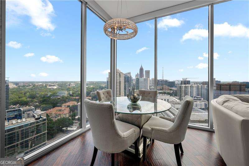Welcome to 1010 Midtown, one of Atlanta's most prestigious luxury high-rises, and home to this stunning 27th-floor corner unit with one of the most desired floor plans in the building. This upscale two-bedroom, two-bath condo is filled with natural light and wrapped in floor-to-ceiling windows that offer uninterrupted views from every single room. The open-concept layout makes an impression from the moment you step in. The oversized kitchen flows seamlessly into the living and dining areas, creating the perfect setting for everyday living and effortless entertaining. One of the most striking features of this home is the expansive balcony that runs the full length of the condo, offering a front-row seat to Midtown's skyline, both day and night. This home is the definition of elevated city living. Residents of 1010 Midtown enjoy access to resort-style amenities including an Olympic-size saltwater pool, a lush SkyPark, outdoor grills and gathering spaces, a fully equipped fitness center, and a beautiful clubhouse with kitchen and meeting areas. The 24-hour concierge service ensures peace of mind and daily convenience. Located in the heart of Midtown, you are steps from Piedmont Park, the Atlanta Botanical Garden, the High Museum, Woodruff Arts Center, and dozens of top restaurants, cafes, and cultural attractions. This is more than a home-it's a lifestyle in the center of it all, with luxury and city energy in perfect balance.