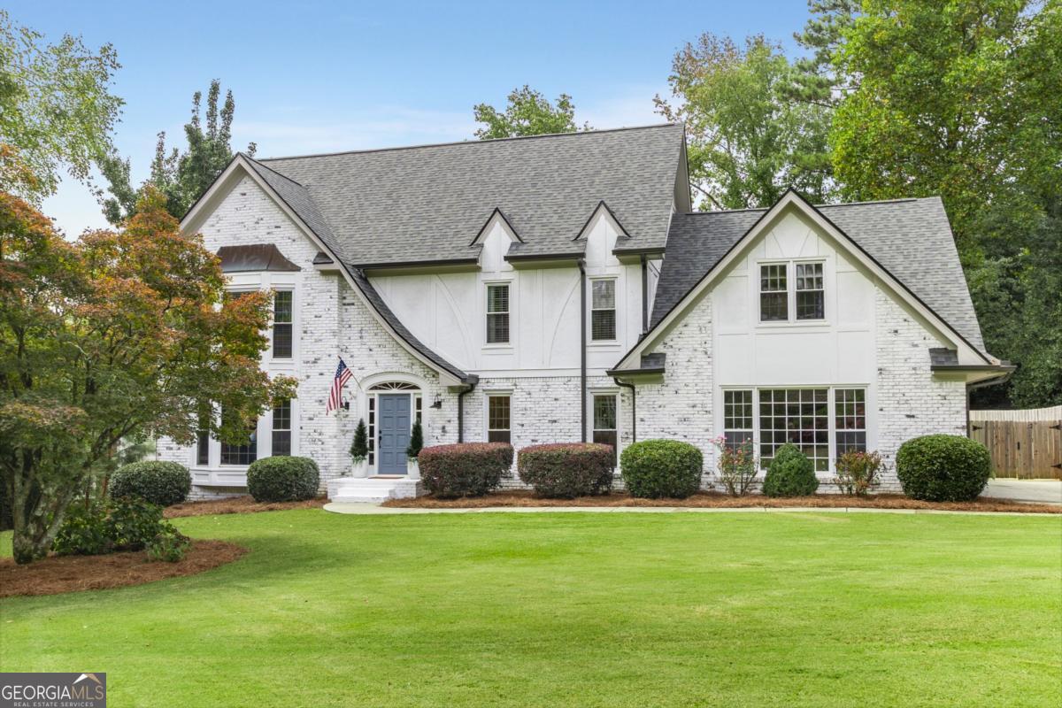 Totally renovated LimeWashed brick traditional in the heart of Dunwoody Sandy Springs offering the perfect combination of timeless charm and modern updates. The inviting foyer opens to a spacious flex room ideal for a home office, study, or playroom and flows seamlessly into a generous family room with brick fireplace, custom shiplap accent wall, and bay window that fills the space with natural light, complemented by a custom built-in beverage bar with ice maker and beverage cooler for added style and function. The stunning chef's kitchen is designed for both everyday living and entertaining, showcasing quartz countertops, a commercial-grade KitchenAid dual gas range with custom vent hood, oversized work island, farmhouse sink, and a separate full-size refrigerator and freezer flanking the kitchen sink, while a sunny breakfast room with built-in seating and custom pantry adds beauty and functionality, and the mudroom with brick flooring, half bath, and convenient friends' entry enhances daily living. Upstairs, the primary suite features a tray ceiling, crown molding, and sitting area, along with a custom walk-in closet and spa-like bath with dual vanities, jetted tub, and separate shower, with three additional large bedrooms each including walk-in closets-one with a private ensuite bath and two sharing a well-appointed hall bath with double vanity-and an oversized laundry room completing the second floor. The daylight basement expands the living space with a brick fireplace, recreation room, workout room, storage, and half bath, while outdoor living is exceptional with a covered porch, deck, fire pit, paver patio, outdoor kitchen, and a large, level, park-like fenced backyard, all enhanced by a two-car side-entry garage and meticulous attention to detail throughout. Deerfield is a charming and well-kept community, showcasing beautiful homes, great amenities, and a prime location near the attractions of Dunwoody and Sandy Springs, with convenient access to parks, top schools, shopping options, and major highways. Updates include all new appliances, quartz countertops in the kitchen, granite on the custom bar and all bathrooms on the top two floors, LVP flooring throughout the main level and brick flooring in the mudroom, new windows, all new electrical panel, HVAC system for all three levels, tankless water heater, new roof and gutters, new retaining wall, paver patio and fire pit added in 2022, new deck in 2020, outdoor kitchen installed 2025, new irrigation system for front and backyard in 2025, all new cabinetry from Keystone Cabinetry for kitchen, pantry, and half baths, and removal of the drop-down ceiling in the basement with drywall and LED lights installed. Neighborhood amenities include a warm and community-oriented atmosphere with access to swim and tennis facilities, nearby parks and green spaces, proximity to top-rated Dunwoody and Sandy Springs schools, and easy access to shopping, dining, and entertainment at Perimeter Center and Sandy Springs City Center, with GA-400 and I-285 just minutes away for convenient commuting throughout Atlanta.