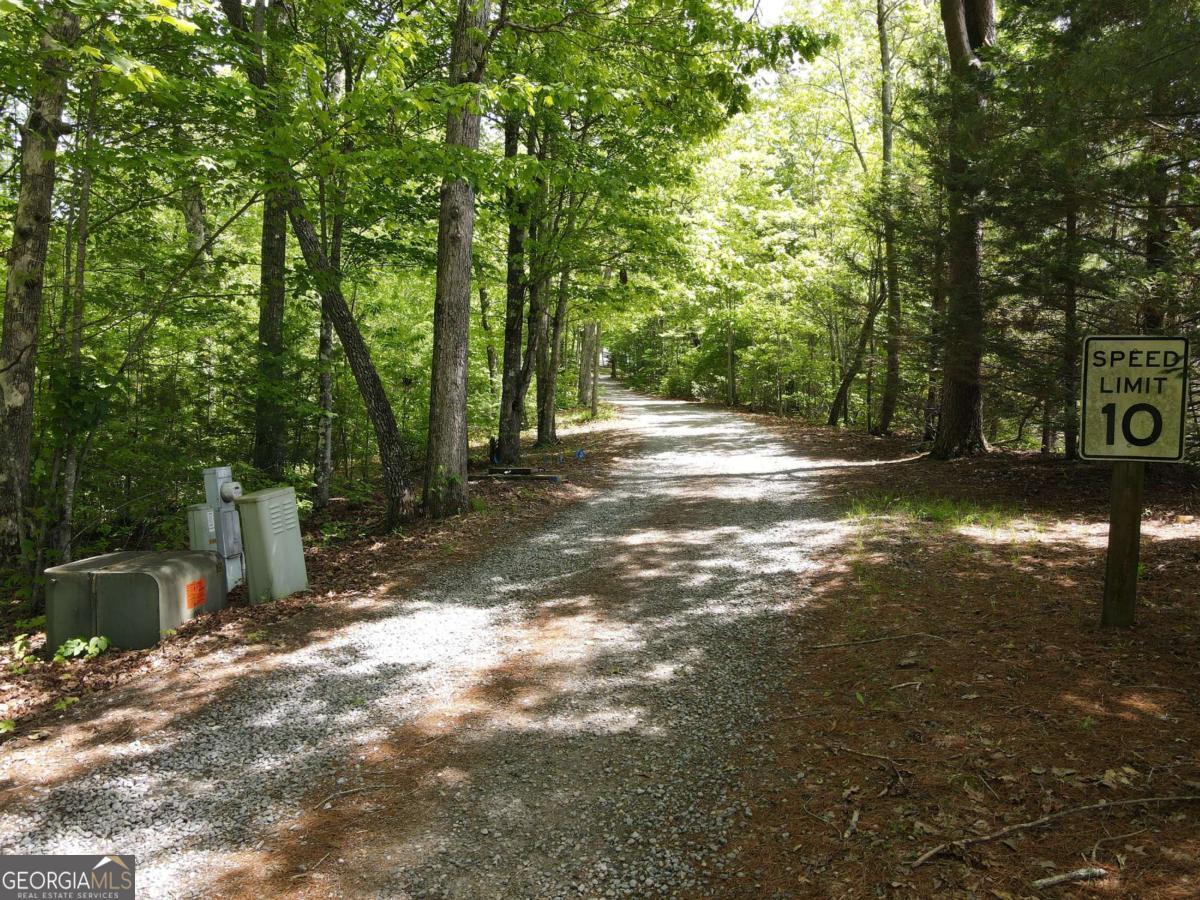Discover the perfect blend of privacy and convenience with this stunning 4.78-acre property, ideally located just minutes from downtown Hiawassee. Nestled among mature trees and natural forest, this serene setting offers the potential for breathtaking, year-round mountain views with selective clearing. Underground utilities are already in place, and a completed soil analysis adds to the ease of building. Whether you're dreaming of a full-time mountain retreat or a peaceful weekend escape, this property offers endless possibilities. Enjoy proximity to schools, shopping, dining, Lake Chatuge, and all that charming Hiawassee has to offer!