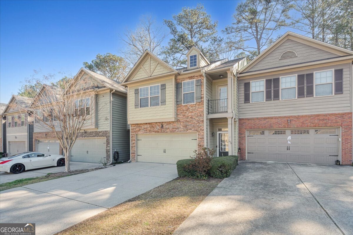 Discover this beautiful craftsman-style townhome, featuring 3 bedrooms and 2.5 baths, now available from its second owner. The home showcases modern updates, including fresh paint, newer flooring, and a brand-new roof. Perfectly situated just minutes from Lake Allatoona, and within easy reach of local dining, shopping, and downtown Woodstock. The main level offers a spacious open-concept great room that includes a dining area with a cozy fireplace. The kitchen is a chef's delight, equipped with upgraded appliances, including a gas range/oven, built-in microwave, refrigerator, and a generous walk-in pantry. Upstairs, the primary suite serves as a tranquil retreat, featuring an en-suite bath, a large walk-in closet, dual vanities, a soaking tub, and a separate shower. Two additional well-sized bedrooms, a full bath, and a laundry room (with washer and dryer included) complete the upper level. Step outside to enjoy a private backyard with a patio, while the HOA manages exterior maintenance, trash collection, roofing, and more. This prime location offers access to award-winning schools and comes with no rental restrictions. Additionally, the Perpetual Financial Group is providing down payment assistance on this property, making it an opportunity not to be missed!