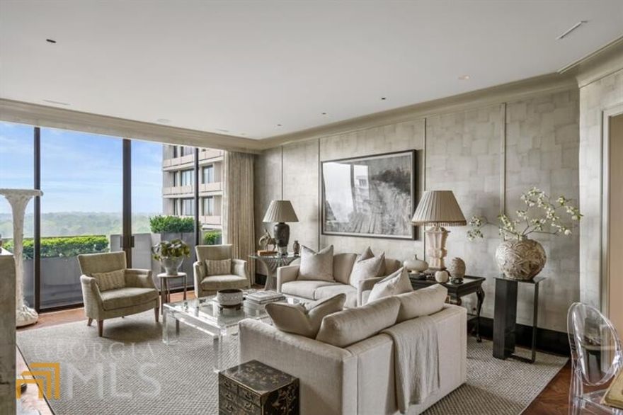Conveniently located in the heart of Buckhead in the iconic Plaza Towers, this spectacular unit is meticulously designed and constructed to the height of sophistication. The living room has been refreshed with an updated neutral color palette and the office has been converted into what can be used as a third bedroom.  The unit offers unobstructed views from all four balconies and with finishes second to none, this one of a kind unit makes for ideal high rise living. Absolutely no detail was overlooked in the stunningly chic 2018 renovation. The unit consists of a primary bedroom with two ensuite bathrooms and closets, a guest bedroom with ensuite bathroom and closet, an eat in kitchen, dining room, living room, study, bar, laundry room and office.  The entry hallway features floor to ceiling reeded paneled walls with brass rod accents, checkerboard floors, hand painted doors by R.L. Goins and a custom bar which makes for ideal entertaining upon entry. The dining room features mirrored Chippendale-style cabinetry adorned with E.R. Butler & Co. brass hardware and sweeping floor to ceiling views.  The Living Room walls are covered in elegant subtle silvery hued tea paper which is illuminated by the western facing light. Another treasure by R.L. Goins is the hand-painted plaster faux fireplace. Off of the Living Room through two cased openings, the high gloss paneling of the Study provides a cozy respite.  The Kitchen is complete with two Miele dishwashers, an AGA range with four ovens, 2 hotplates and an induction cooktop. The spacious island and countertops are honed Calacatta Borghini marble. The kitchen cabinets are embellished with brass handles and black crystal knobs.  This gorgeous home is a masterpiece and must be seen in person to truly appreciate its magnificence.