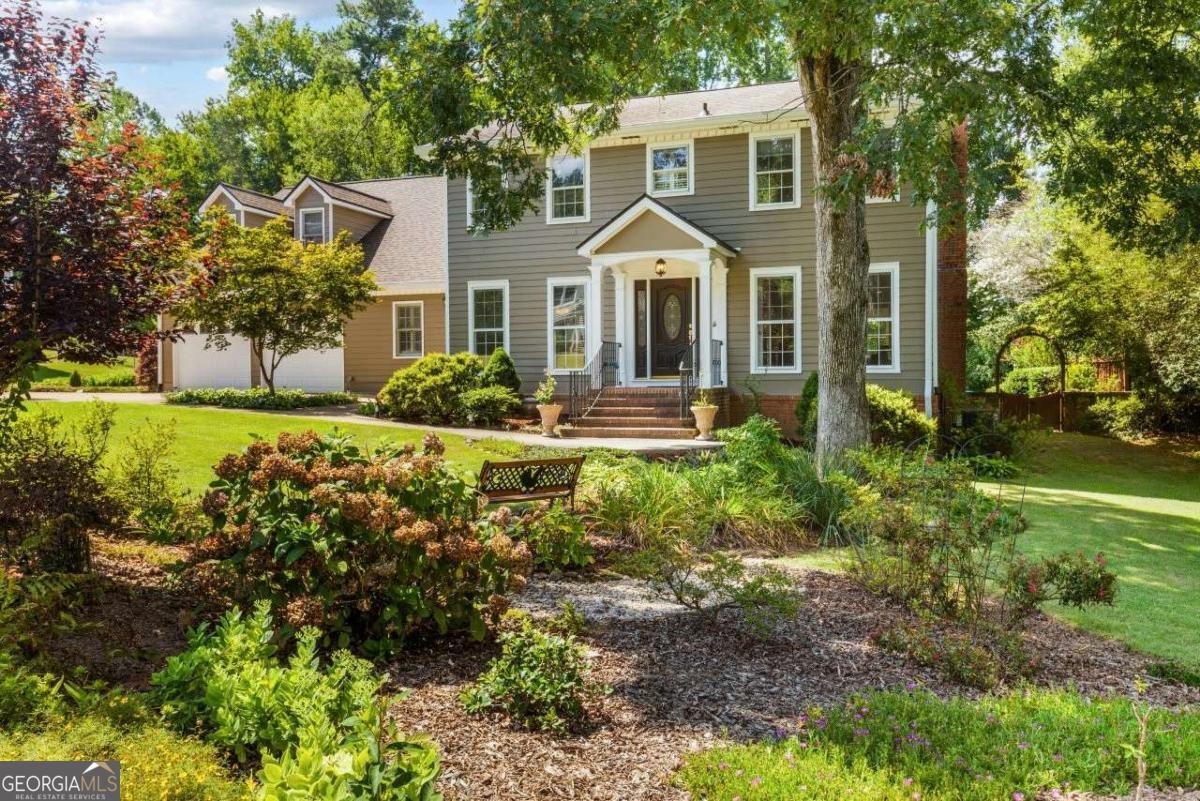 Welcome to this beautifully expanded and meticulously maintained home offering 5 bedrooms, 4.5 bathrooms, and over 4,300 square feet of living space on a private, fenced 1/2-acre lot. Located in one of East Cobb's most sought-after school districts-Murdock, Dodgen and Pope High-this home is much larger than it appears from the street. The main level features a full guest suite with bedroom and bath, an office, formal dining room, den with marble fireplace and oak trim, a large living room, and an expansive gourmet kitchen with custom cherry cabinetry, center island, porcelain floors, breakfast bar, pantry, oven, microwave, warming drawer and gorgeous views of the lush backyard. The kitchen opens into a bright breakfast room and a beautiful sunroom/playroom-perfect for relaxing or entertaining. A major addition provides even more space, including a second pantry, spacious laundry room with sink and cabinets, and an extra-large bonus room accessed via rear stairs-ideal as a playroom, home gym, or media room. Throughout the main living areas, you'll find hardwood and tile flooring, with carpet only in the bonus room. The garage is thoughtfully upgraded with epoxy floors, insulated doors, a small workshop area, and a side room for garden storage. Outside, enjoy a professionally landscaped backyard filled with flowering bushes and a large stone patio featuring built-in seating, landscape lighting, and a chef-grade built-in gas grill. Additional highlights include an updated primary bathroom with separate tub and shower, double vanities, and a large walk-in closet, two HVAC systems for comfort and efficiency, a 50-year architectural shingle roof with gutter toppers, front and rear staircases, walk-in closets, cedar closets, and abundant storage throughout. This is a rare opportunity to own a spacious and truly custom home in East Cobb. With room to spread out, high-end finishes, and an unbeatable location, this home is a must-see.