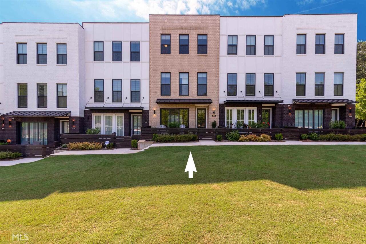 The most sought after floor plan! This RARE 4 bedroom townhome is nearly new and has all the upgrades that others don't: 5" hardwood floors, 8' doors, custom window treatments, new stainless steel refrigerator, 42" cabinets with under cabinet lighting, top of the line Calcutta quartz countertops, upgraded tiled bathrooms (master has rain shower and double shower heads; secondary have subway tile), extra recessed lighting package. front brick exterior, owner's suite with dual walk-in closets, triple track sliding doors in lower bedroom opens to a fenced front courtyard & large rear deck off family room. HOA paid through end of year! Whole Foods, Sprouts, Walmart, Dekalb Farmers Market, downtown Decatur, 40-acre horse park & walking trails all nearby.