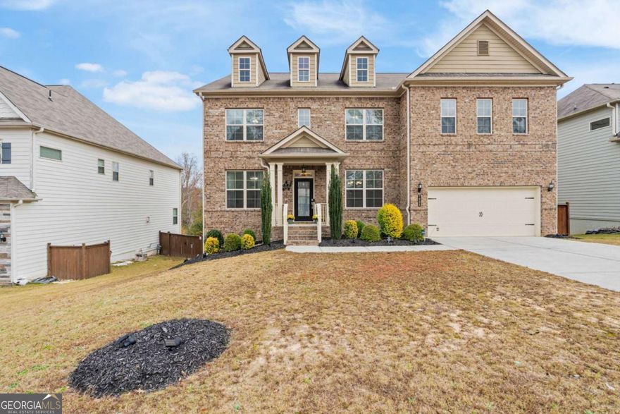 Welcome to a home that truly offers it all: 5 bedrooms, 4 baths, and over 4,200 sqft, perfectly situated in one of the area's most desirable neighborhoods.    This house is the LARGEST FLOOR PLAN in the community, and it's designed for both grand entertaining and comfortable everyday living. The main level features gleaming HARDWOOD FLOORS and a bright, open-concept flow, centered around a CHEF-INSPIRED KITCHEN. It boasts a large center island, a sunlit breakfast area, a spacious pantry, and a dedicated butler's pantry for effortless hosting. The kitchen seamlessly connects to a cozy family room anchored by a gas fireplace. The formal dining room provides a dedicated space for entertaining, while the convenient guest suite with an en-suite bath can also serve as a versatile MAIN-LEVEL OFFICE.    Upstairs, the expansive owner's suite provides a luxurious private retreat. You'll find a SPA-LIKE BATH and an OVERSIZED WALK-IN CLOSET, ensuring a peaceful start and end to your day. The three additional generously sized bedrooms are thoughtfully designed, two with a shared bath, and the third featuring its own private en-suite. A dedicated upstairs laundry room provides unmatched convenience.    The lower level offers both immediate entertainment and future potential. This partially finished space currently hosts a THEATER ROOM designed to seat up to ten people. The rest of the basement features over 1,500 SQFT OF UNTAPPED POTENTIAL, perfect for customizing your own home gym, game room, or versatile bonus space.    Outside, enjoy your private COVERED DECK, ideal for setting up your perfect grilling or relaxation spot, rain or shine. You'll also benefit from top-rated schools and exceptional neighborhood amenities.    AREA HIGHLIGHTS: This prime location is conveniently located within a 20-minute drive of the Cumming City Center, Historic Downtown Ball Ground, and the North Georgia Premium Outlets. The exciting new Coal Mountain Town Center, currently under development with shopping, dining, and entertainment, is just 10 minutes away. Plus, the beautiful North Georgia mountains and an expansive offering of wineries are only a scenic 45-minute drive.    Don't miss the opportunity to own this truly move-in ready home! Schedule your showing today.