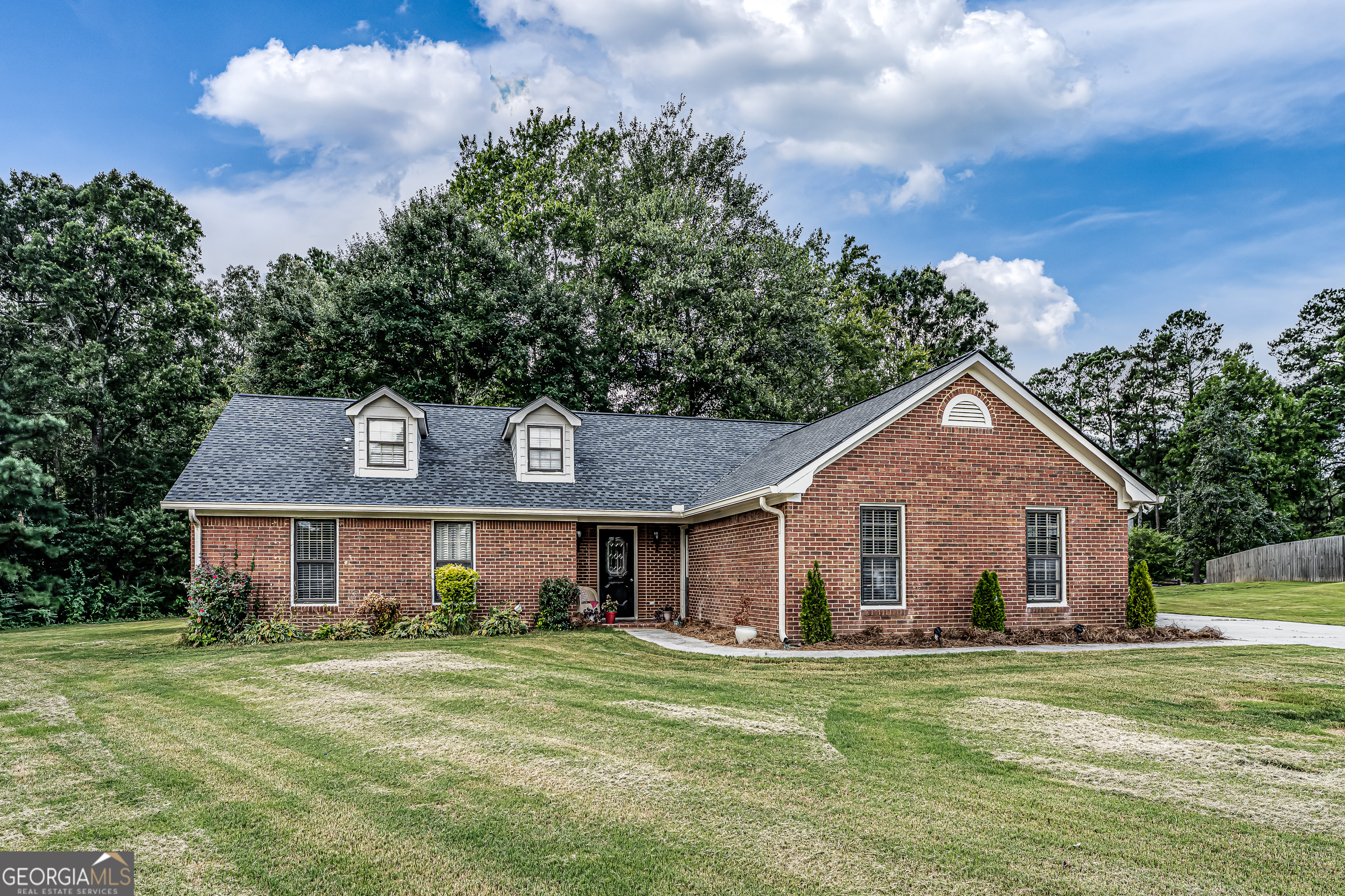 Welcome to Northwoods! This well-maintained 3-bedroom, 2-bathroom brick home features vaulted ceilings, a cozy fireplace, and a spacious kitchen that opens to the dining area. Convenient laundry access, great-sized bedrooms, and a new roof add to the appeal. Outside, enjoy a patio area, two outbuildings, and a 2-car attached garage. Don't miss this move-in ready home!