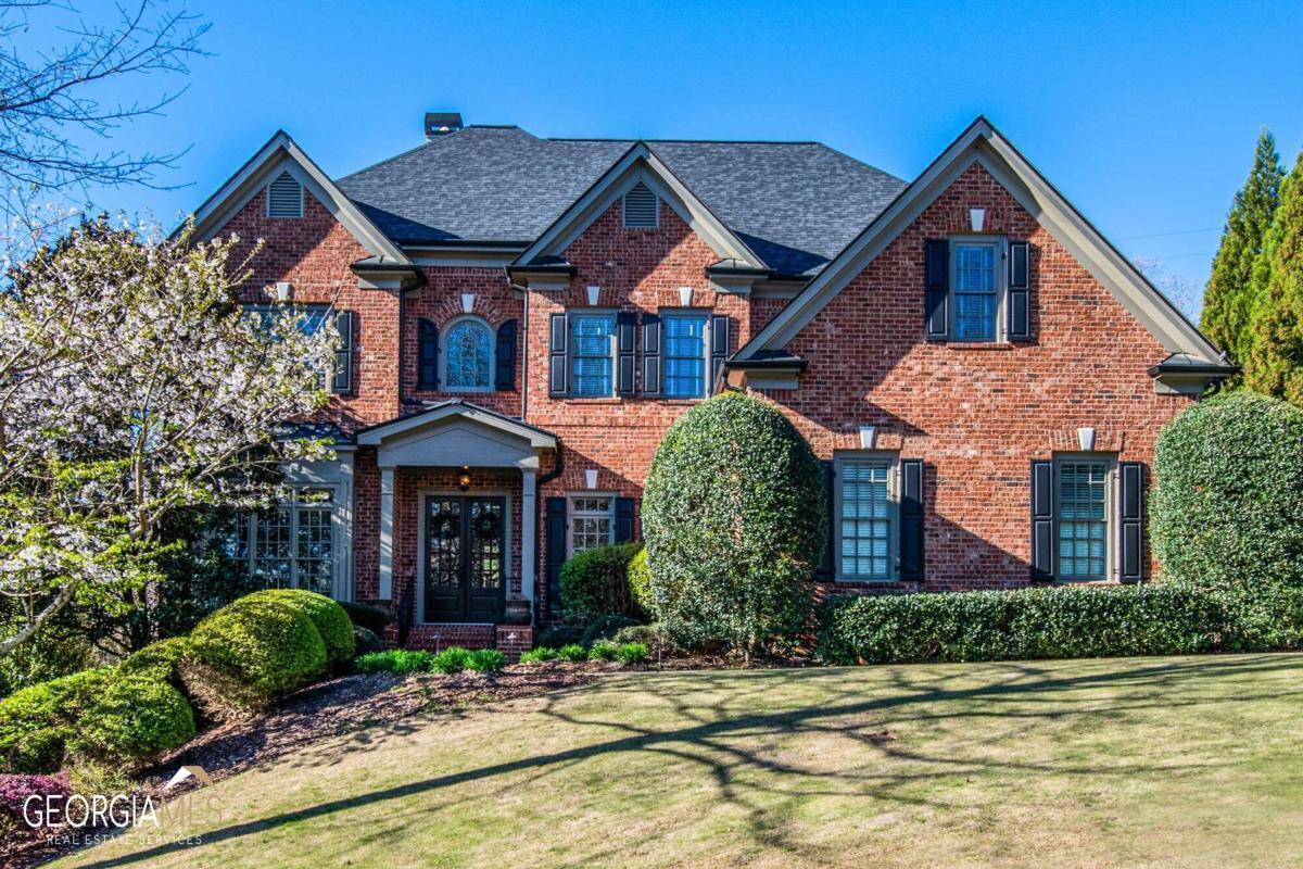 Spectacular 6 bedroom, 5 bath custom home with upgrades throughout in Vinings Estates. Gourmet kitchen with top of the line appliances including a Subzero refrigerator, Miele built-in coffee maker, American Range dual ovens, warming drawer and cooktop, Bosch dishwasher, pot filler and copper sink. The spacious foyer opens to an office and a dining room with beautiful trim and wainscoting. The fireside living room has a wall of windows overlooking the backyard. The eat-in kitchen opens to the family room with a stone fireplace and built-in bookcases. The primary bedroom is upstairs with a luxury bathroom, large, custom, walk-in closet and gas fireplace. Three additional secondary bedrooms upstairs with two bathrooms. Hardwood floors throughout the home. The finished terrace level includes a theater room, kitchenette with an ice maker and two beverage fridges and a fireside sitting area. Game room for pool/ping pong and darts. The gym could also be used as a bedroom. This home has a large back deck with composite decking and a stone fireplace with a sitting area overlooking the quiet, private fenced in backyard. Vinings Estates features two clubhouses, three pools, tennis courts, pickleball courts, fitness center and a playground. Close to Whitefield Academy.