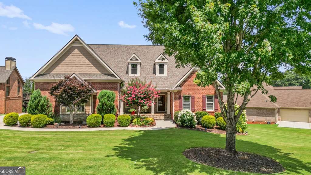 4 SIDED BRICK, former model home, located in widely popular neighborhood of Bradshaw Glen. TWO bedrooms on the MAIN floor, the Owner's bedroom plus a secondary with a private bathroom. Both have walk in closets. Cozy, two-sided brick screened porch with wood ceiling, heaters and solar shades. The large deck overlooks the backyard. The oversized yard could easily accommodate pool, garden or just a beautiful view. The patio below the deck has brick pavers which leads to a woodburning firepit. This open floorplan has many upgrades plus extra wide doorways that could accommodate most wheelchairs. Both levels have been recently painted. Newly installed carpet on main level living and bedrooms plus traditional hardwood floors in kitchen, keeping room and dining rooms. Two fireplaces on the main level, one is wood burning and the other one gas....both have gas starters. Two large bedrooms on the second level, and a fifth bedroom on the lower level. The entire front and back yards are "wired" for invisible fence for dogs. The finished basement is AMAZING! A full-service bar with built-in dishwasher, cleanup sink and full-size refrigerator. The custom cabinetry has pull out shelves for glassware. Glass shelving with "up lighting" as well as undercounter lighting. The game room is big enough for a pool table. The sitting room has a ventless fireplace with gas logs. The entire basement has been insulated with heat and air. There are 3 unfinished rooms in the basement. One area has a designated workshop. There is also a safe room and extra-large storage room. Convenient commute to downtown Woodstock and Riverwalk shopping and yet only minutes from Hickory Flat. Owner is also a licensed real estate agent in Georgia.