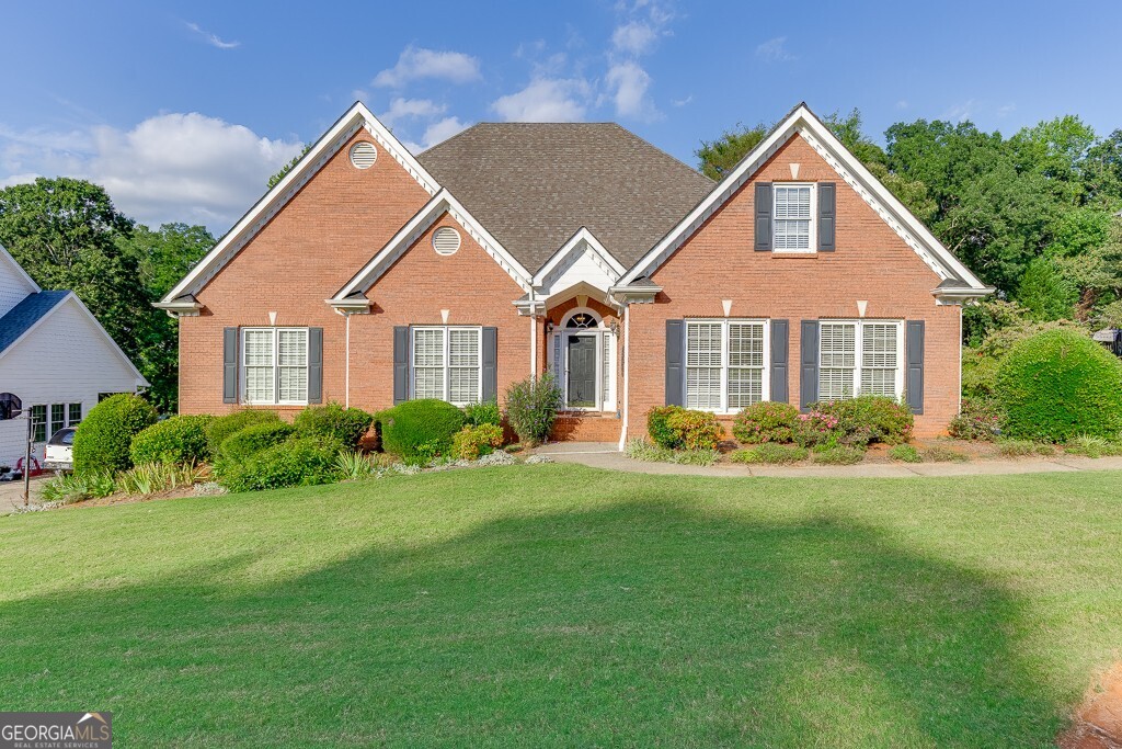 ALL NEW INTERIOR PAINT & CARPET! Priced BELOW Appraised Value! Welcome to your new home in the highly sought-after Chateau Corners community in Hoschton, GA! This 4-bedroom, 3-bathroom home, with an unfinished basement, offers the perfect blend of Southern charm, comfort, and potential. Step inside and enjoy single-level living with a versatile upstairs bonus room/4th bedroom and full bath ideal for guests or a private home office. The spacious great room features an incredible stacked stone fireplace flanked by built-in bookshelves, creating a cozy and elegant centerpiece. The kitchen is flooded with natural light, perfect for enjoying your morning coffee, and offers a welcoming space for cooking and entertaining. The oversized primary suite includes an en-suite bath with a whirlpool tub, double vanity, and a separate shower for your daily retreat. Two generous secondary bedrooms on the main floor share a well-appointed full bath with double vanity sinks, ideal for busy mornings. Upstairs, the bonus bedroom with full bath adds flexibility to fit your lifestyle. Enjoy the outdoors on your private back deck, overlooking a beautifully landscaped yard filled with blooming flowers, your personal garden oasis. Additional features include: unfinished basement ready for your customization, new interior paint, carpet throughout, and HVAC membership with 2 additional service visits included. Convenient access to I-85 & I-985, Northeast Georgia Medical Center, Chateau Elan, Lake Lanier, shopping, dining & entertainment. This home offers both comfort and convenience, and it's priced to sell below appraised value. Don't miss your chance to make it yours! Schedule your private showing today!