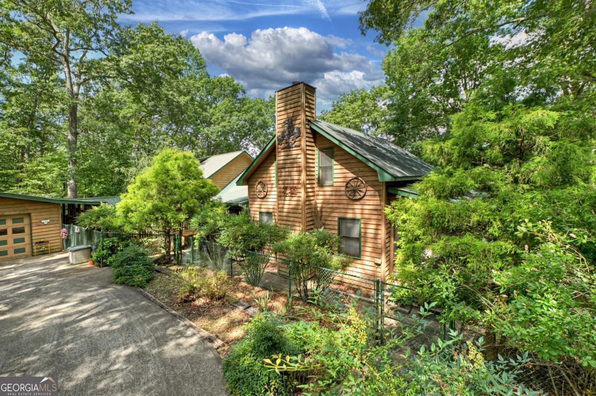 Mountain Retreat with LONG RANGE MOUNTAIN VIEWS with TOCCOA RIVER ACCESS on 11.27 Acres in beautiful Mineral Bluff, Ga. This stunning mountain estate offers breathtaking views and 11.27 acres with access to the Toccoa River. Whether you're dreaming of a family retreat, bed and breakfast, short-term rental, or a private estate with room to expand and roam, this property has endless potential. The two-story family room welcomes you with 12"wood paneling, a custom wagon wheel railing, and a cozy wood stove. The oversized master suite features its own sitting area, two walk-in closets, and ensuite bath. A second upstairs bedroom boasts of a custom red oak vaulted ceiling and unique Queen Anne textured walls, creating a warm and rustic feel. Another upstairs HUGE bedroom with ensuite perfect for anyone wanting privacy and space. Step outside to the second-level covered real deck and soak in the sweeping mountain views-an ideal spot for morning coffee or evening relaxation. Multiple porches and decks surrond the home, offering peaceful places to enjoy the scenery and fresh mountain air. The kitchen and dining area are open and welcoming. For the hobbyist or craftsman, the oversized garage includes a 15x25 workshop with 220v power and a 3-stall drive-under garage. This one-of-a-kind mountain retreat is a rare find-private, peaceful, and packed with charm!!! Don't miss your chance to own a slice of North Georgia!!!