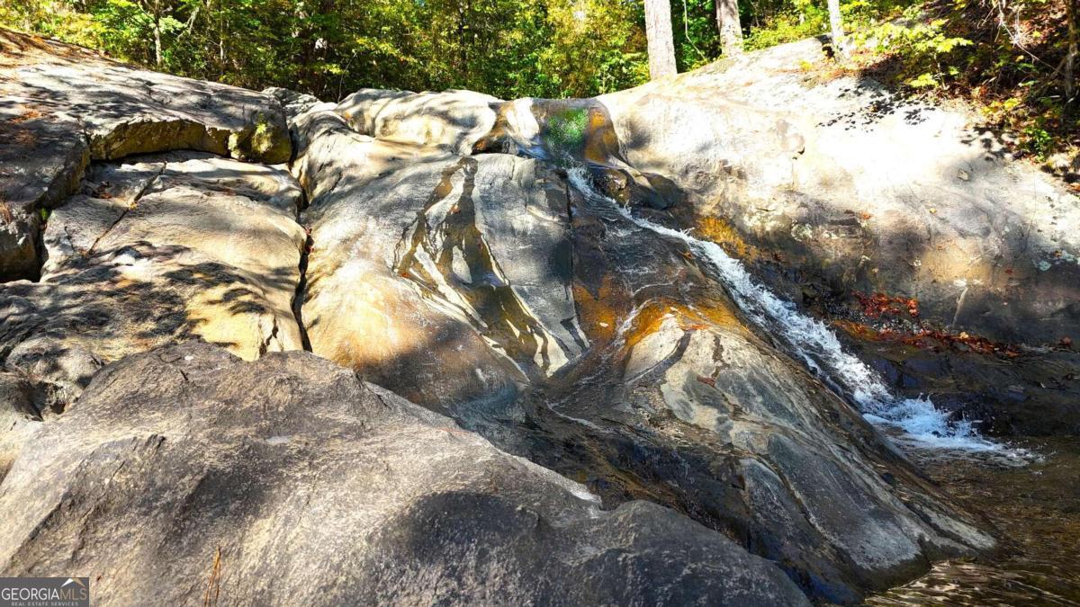 WATERFALL WATERFALL WATERFALL! Once in a LIFETIME opportunity to own your PERSONAL WATERFALL! This historic 49 Acre tract has come available and is truly an incredible land tract. If you are looking for your own private reserve for hunting, ATV riding, exploration or the place to build your own retreat this is the SPOT! My client negotiated access to this tract through the Georgian Park Community in West Paulding County with the Paulding County Board of Commissioners and effectively saved a truly incredible property. Many locals have heard of the Mulberry Rock Waterfall but until now the property was all but inaccessible, tucked in between large land owners this tract was in danger of being landlocked and lost to time but through exhaustive efforts and negotiations the county agreed to allow an ingress/egress easement across the lot that was deeded to the county to maintain the neighborhood detention pond. My client has cleared a road and built a bridge to cross the headwaters of the Little Pumpkinvine Creek which winds across this tract of mature pines and hardwood bottoms and ends at the waterfall. The county agreed to this permanent access on the condition that only one home could be built on the property! Less than 45 minutes from downtown Atlanta this special property is waiting on the special owner! Call today to schedule a private tour on the listing agent's Utility Vehicle and see one of the most incredible land tracts in all of West Georgia!